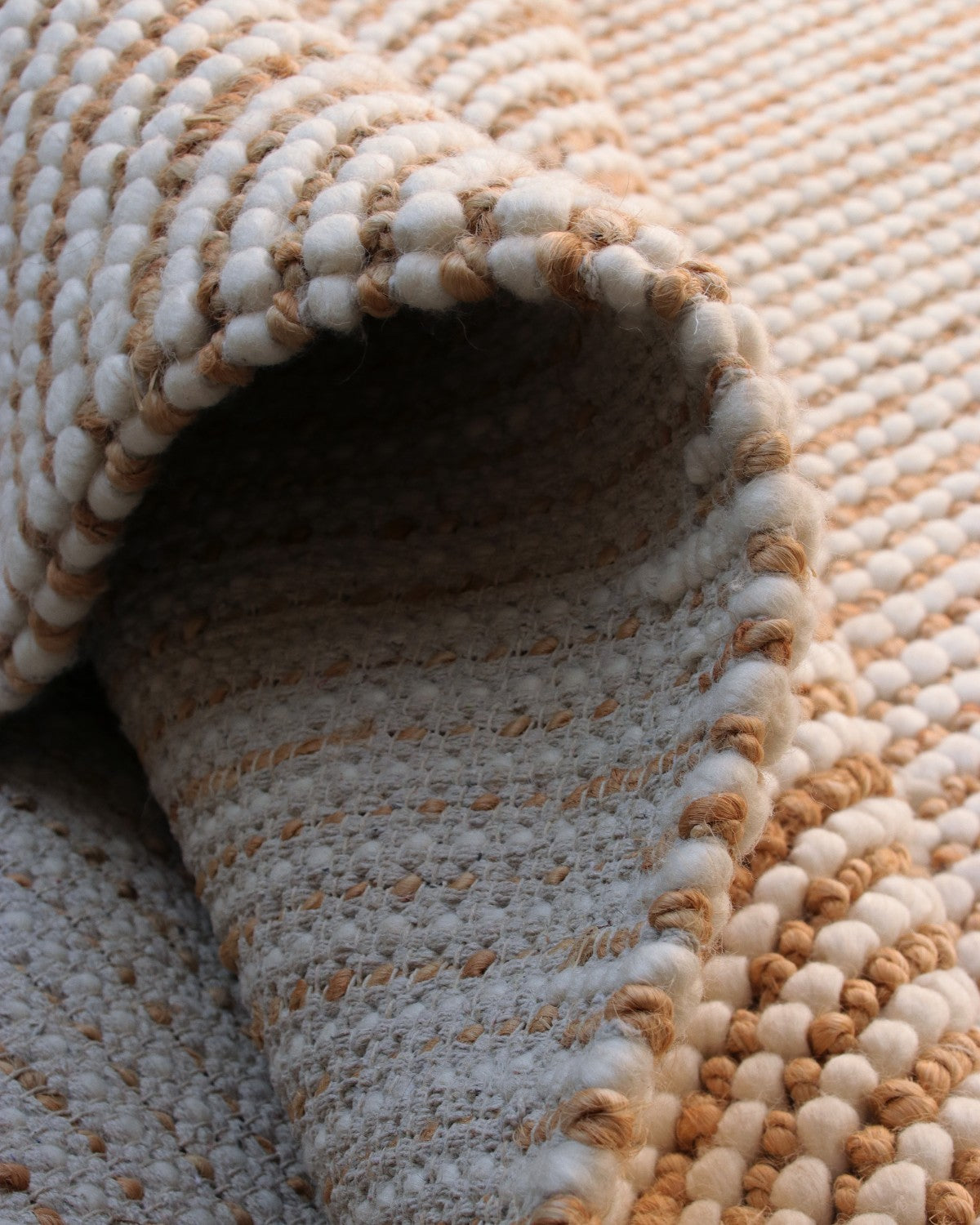Folded drape demonstrating the durable, heavy profile of the handwoven 18mm flatweave designed for coastal living.