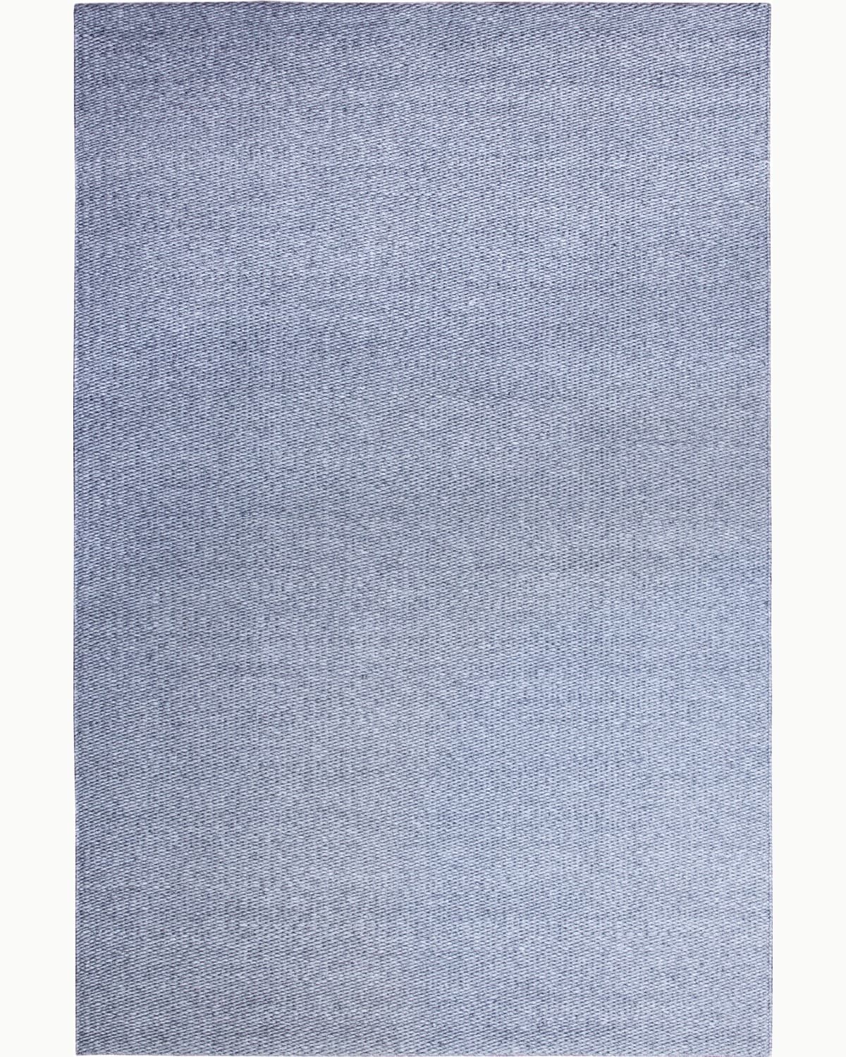 Full overhead view displaying the calm, linear rhythm and plush 15mm pile height for a timeless living room anchor.