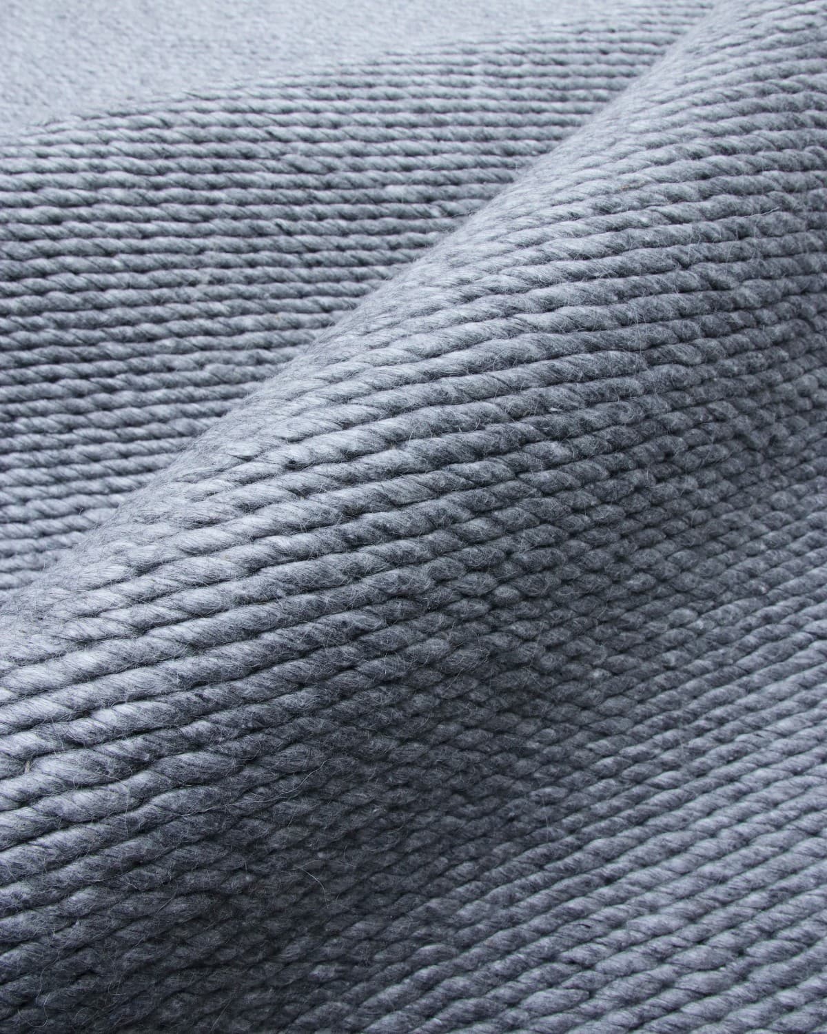 House of Bohi Buna charcoal wool area rug showcasing a thick, handwoven flatweave with a braided texture.