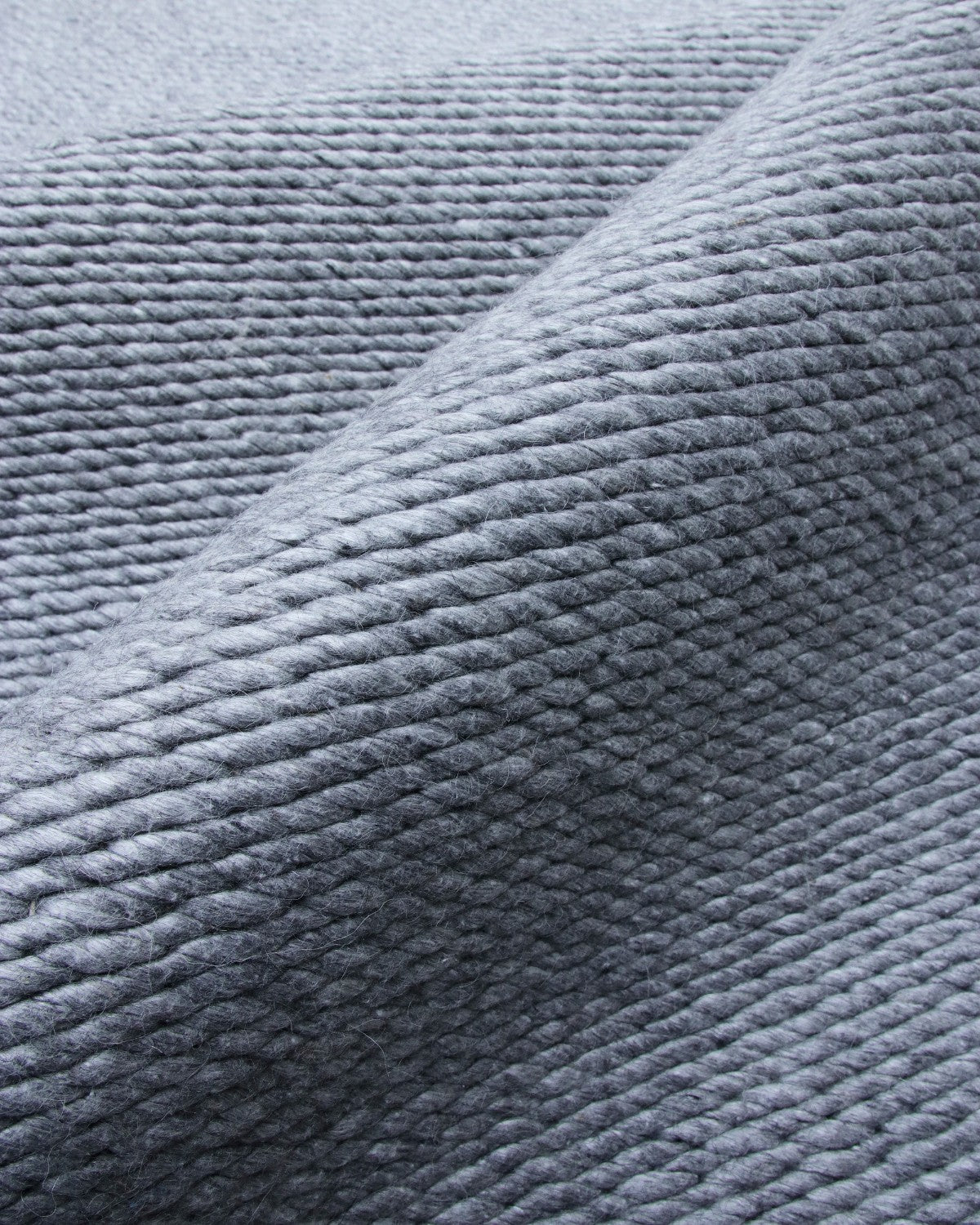 House of Bohi Buna charcoal wool area rug showcasing a thick, handwoven flatweave with a braided texture.