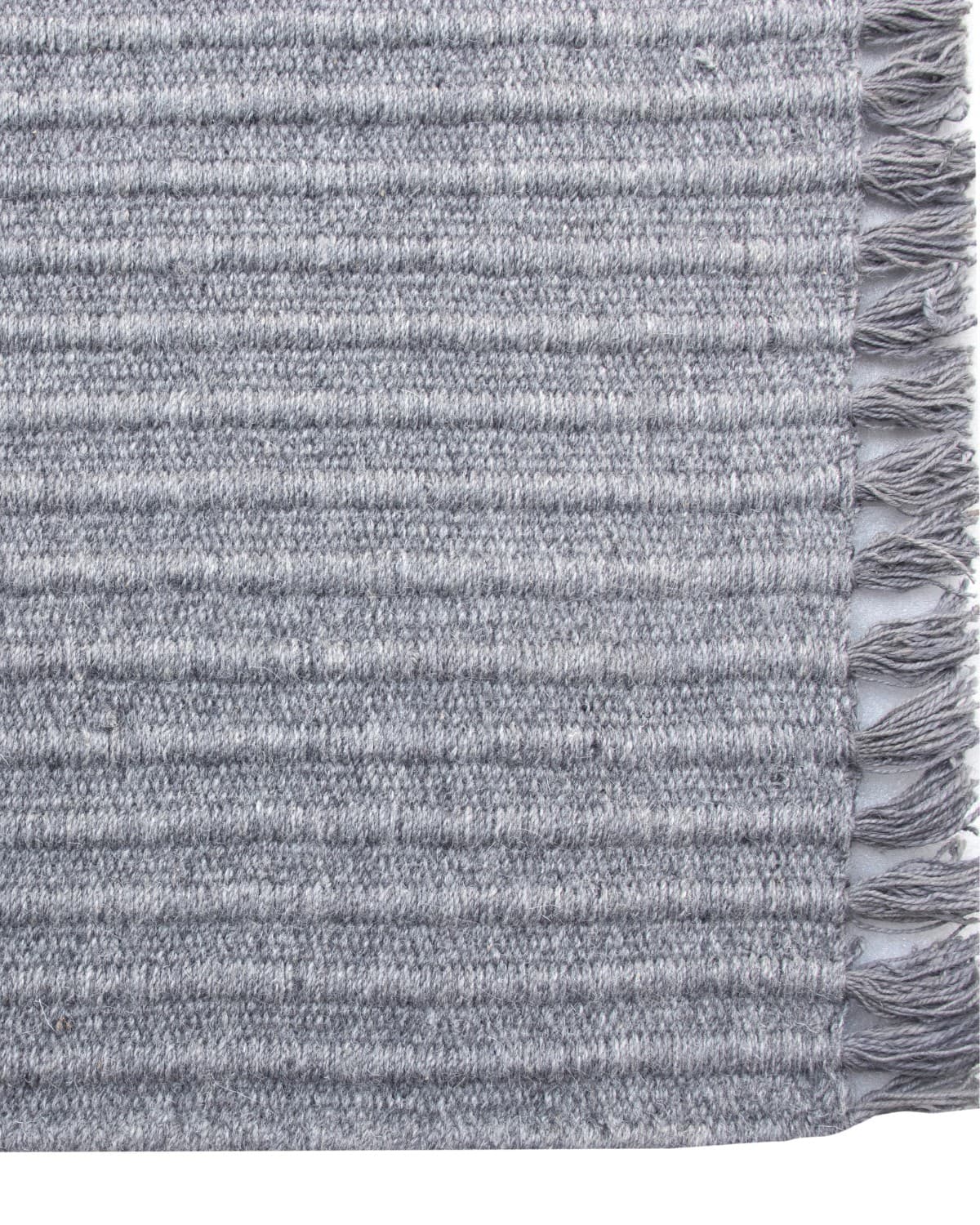 Playful fringe edge of a flatweave runner, ethically handmade in Bhadohi, India and GoodWeave certified for an entryway.
