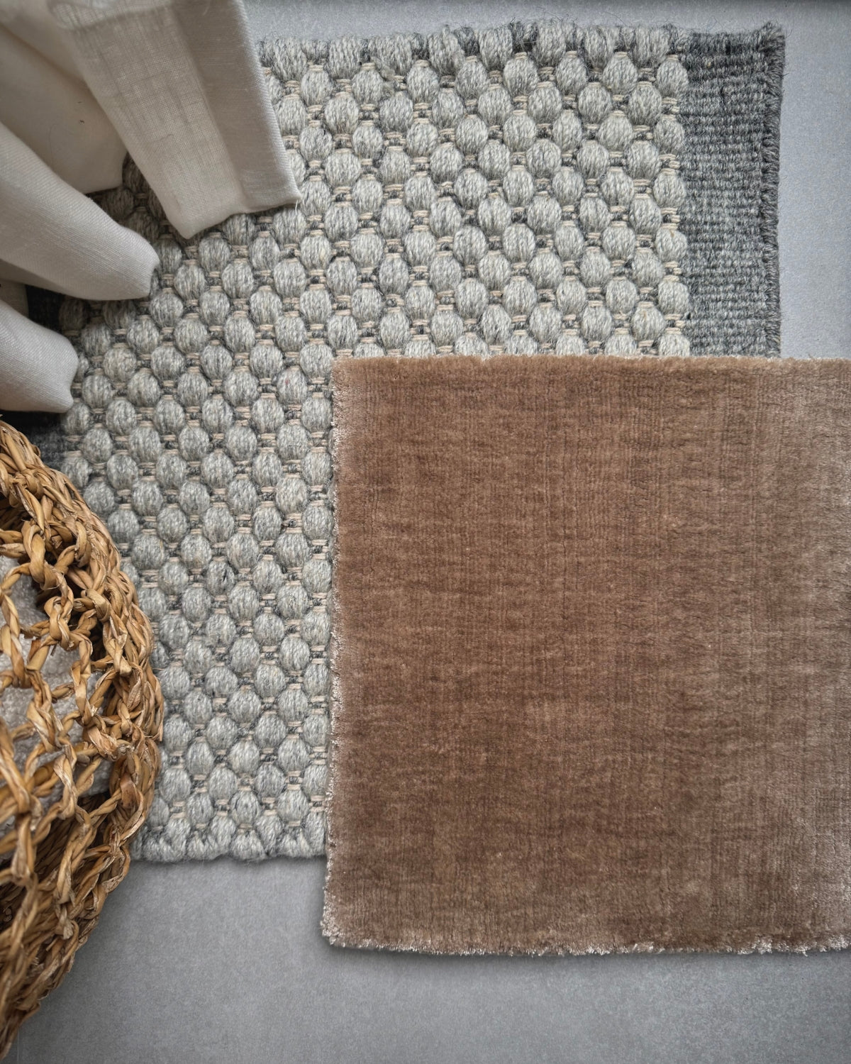 Neutral handmade rug samples showing different textures and weaves like flatweave and handloom for the House of Bohi rug sample service.