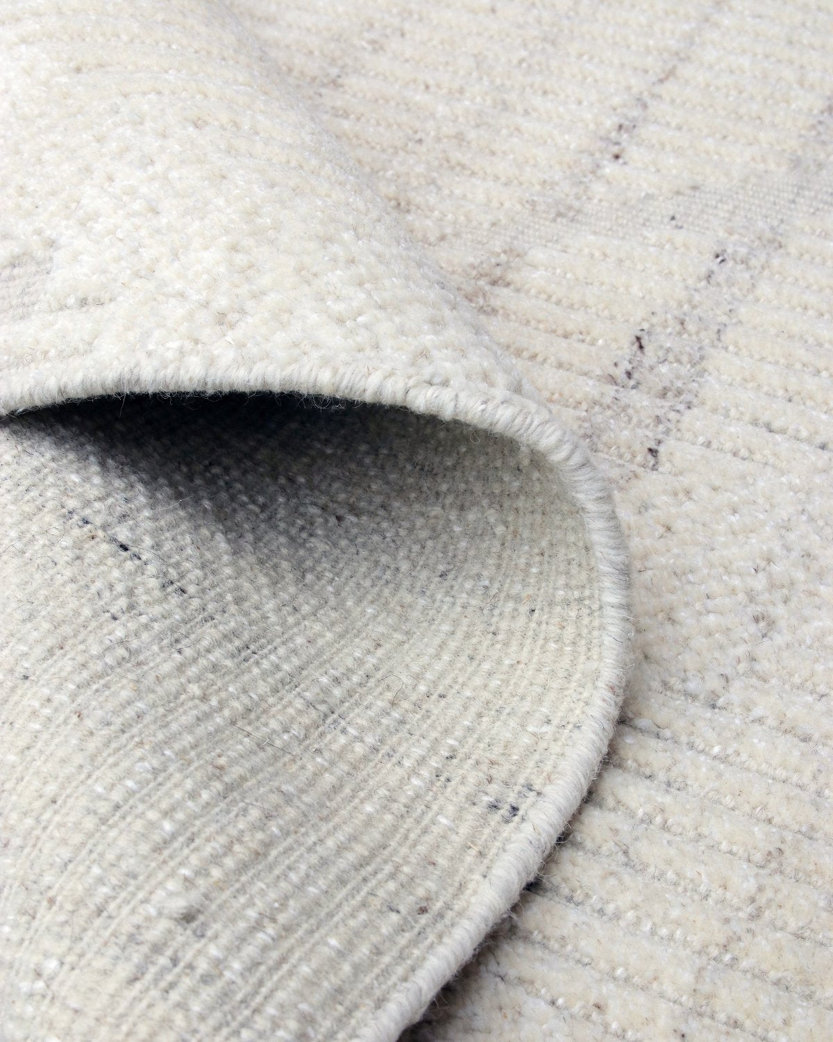 Folded corner showing the edge finish of this GoodWeave certified rug, ideally suited for a modern living room or bedroom.