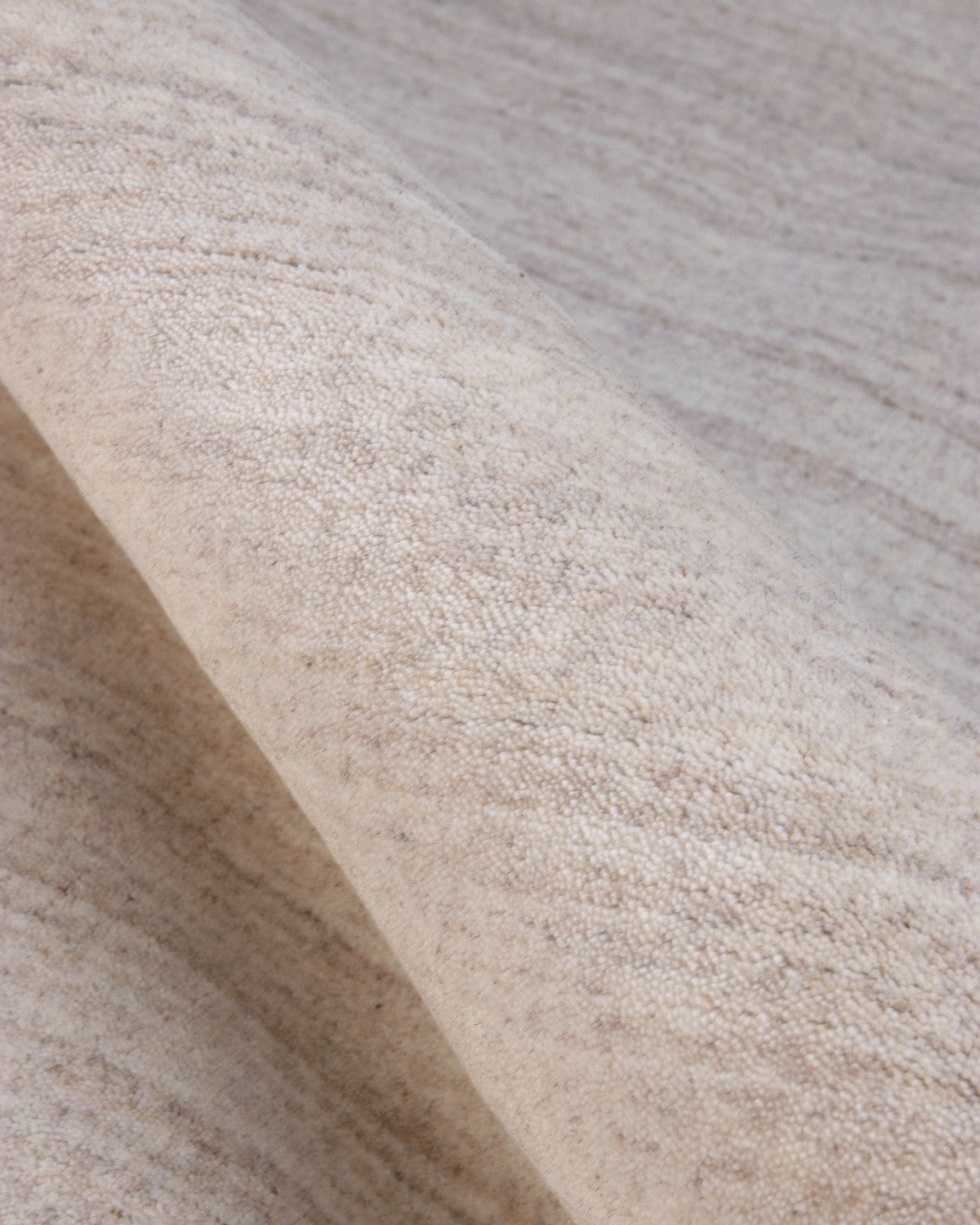 Close-up of a 70% New Zealand wool and 30% viscose blend, showing a lustrous sheen and a precise 12mm pile height.