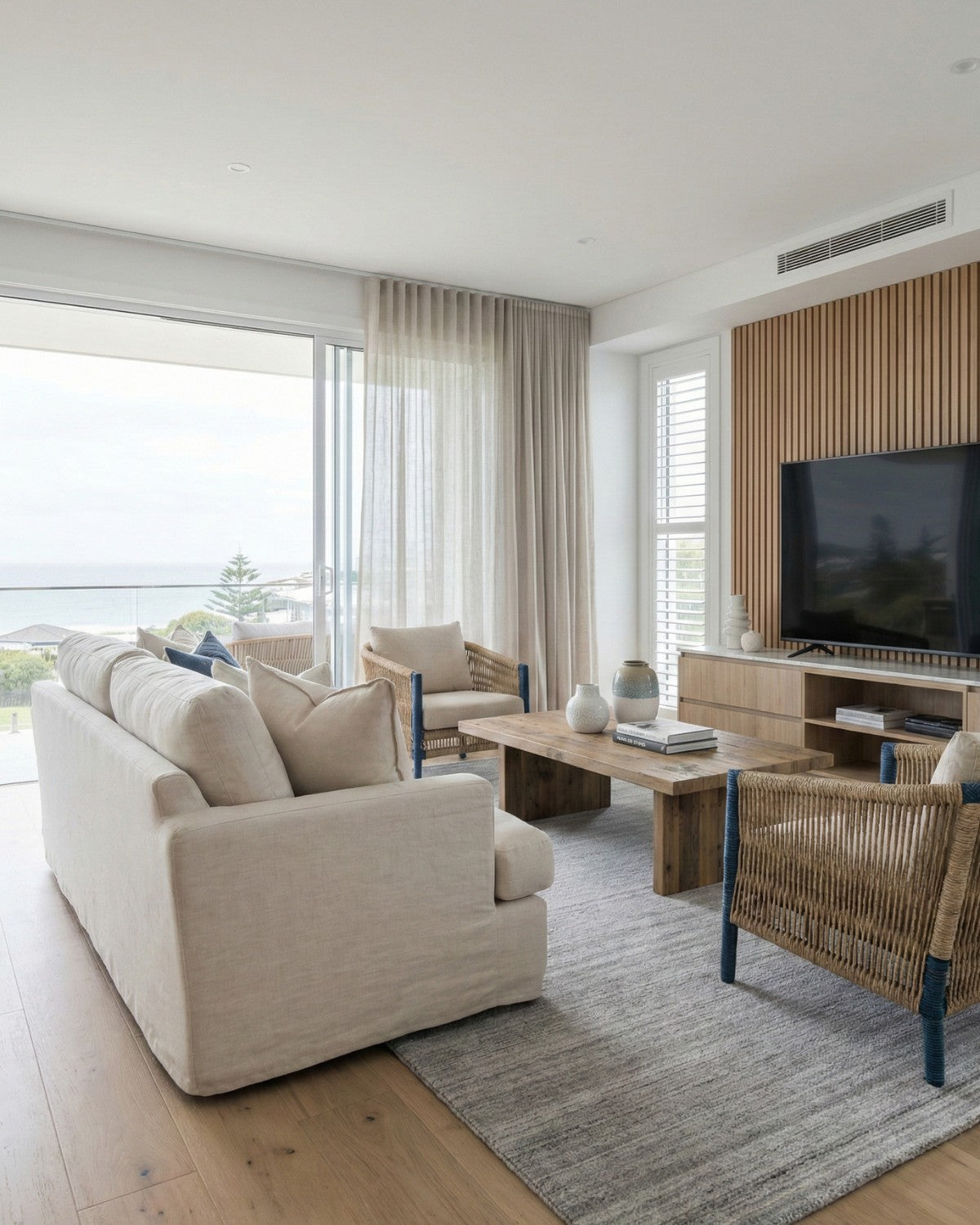 Luminous silver grey cut pile area rug bringing serene composure to a modern coastal living room, ethically handmade in India.