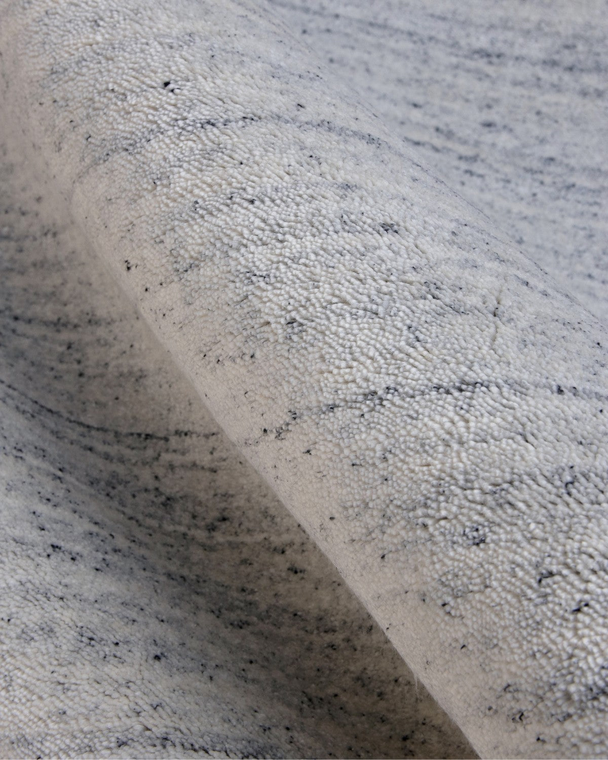 Close-up of a 70% New Zealand wool and 30% viscose blend, showing a lustrous sheen and a precise 12mm pile height.
