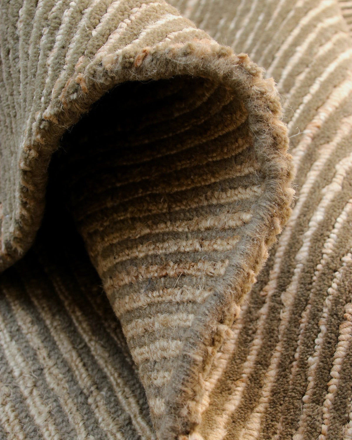 A folded section reveals the 15mm pile height and resilient texture, perfect for grounding a living room or bedroom.