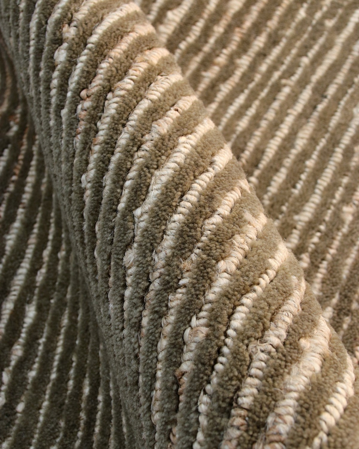 Close up of a handknotted cut-and-loop weave showing alternating rows of plush wool and sturdy jute for earthy elegance.