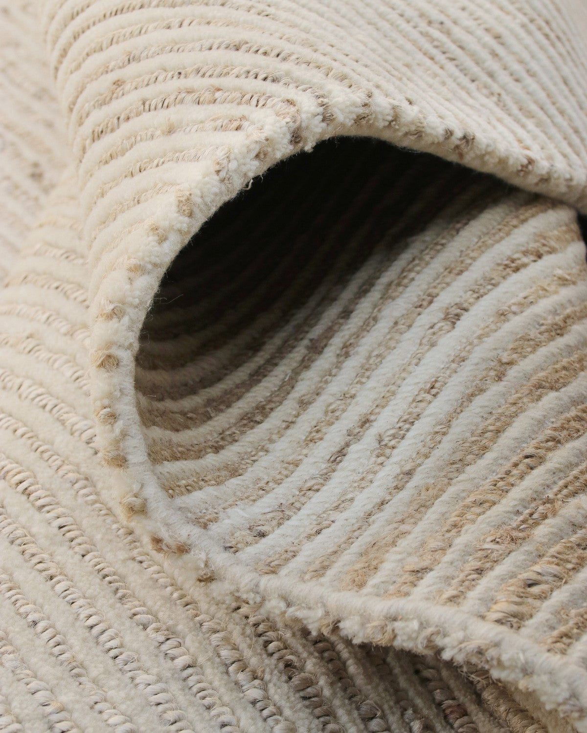 A folded view revealing the 15mm pile height, offering earthy elegance and a resilient foundation for a living room.