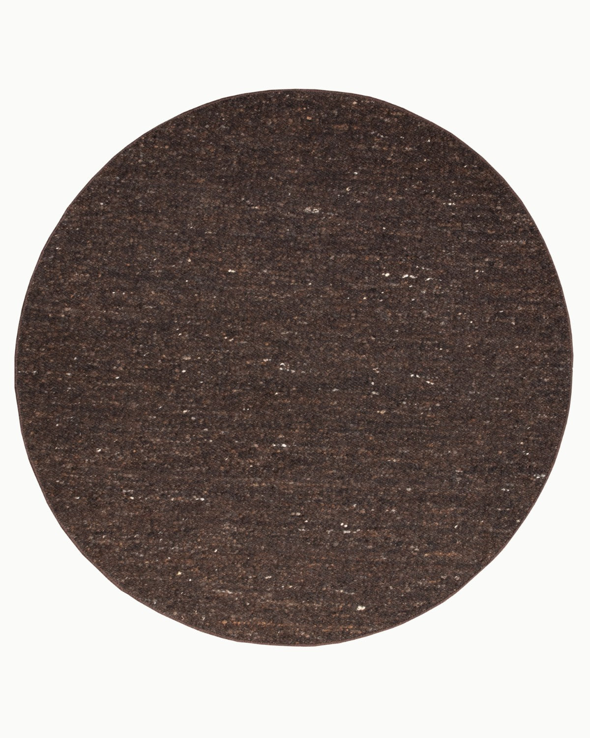 Overhead view of the circular variation, an ethically handmade, GoodWeave certified Indian floor piece perfect for a bedroom.
