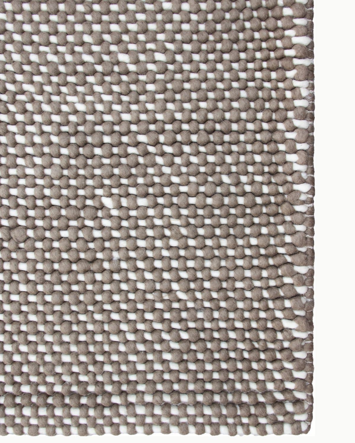 Detailed view of the neat edge binding on this GoodWeave certified, ethically handmade Indian floor piece built for high-traffic living.