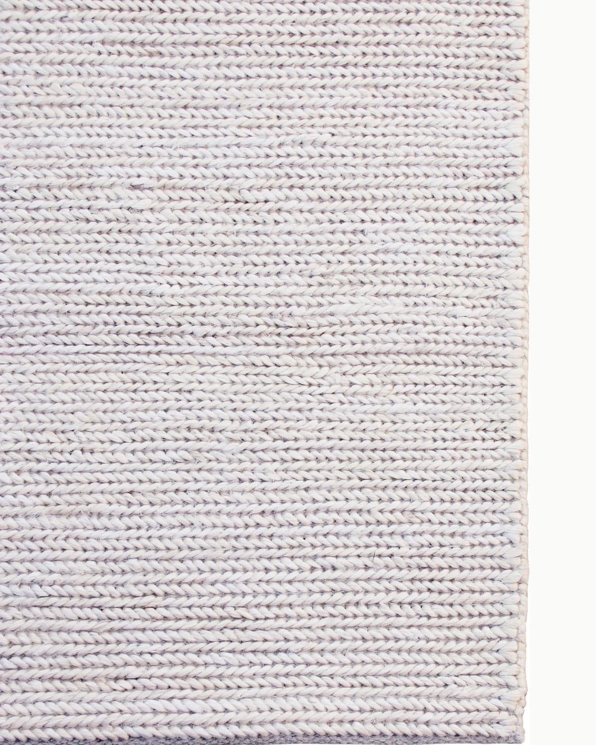 Detailed view of the neat side binding on this GoodWeave certified, ethically handmade Indian floor piece shaped by quiet intention.