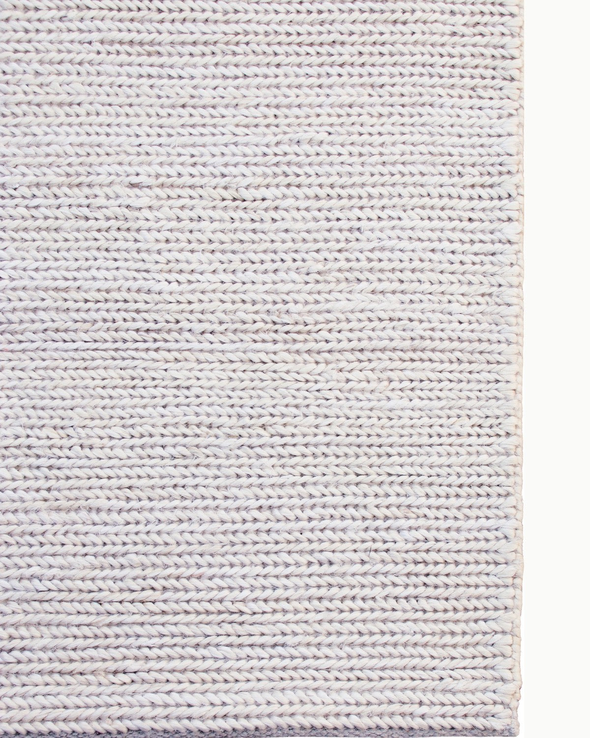 Detailed view of the neat side binding on this GoodWeave certified, ethically handmade Indian floor piece shaped by quiet intention.