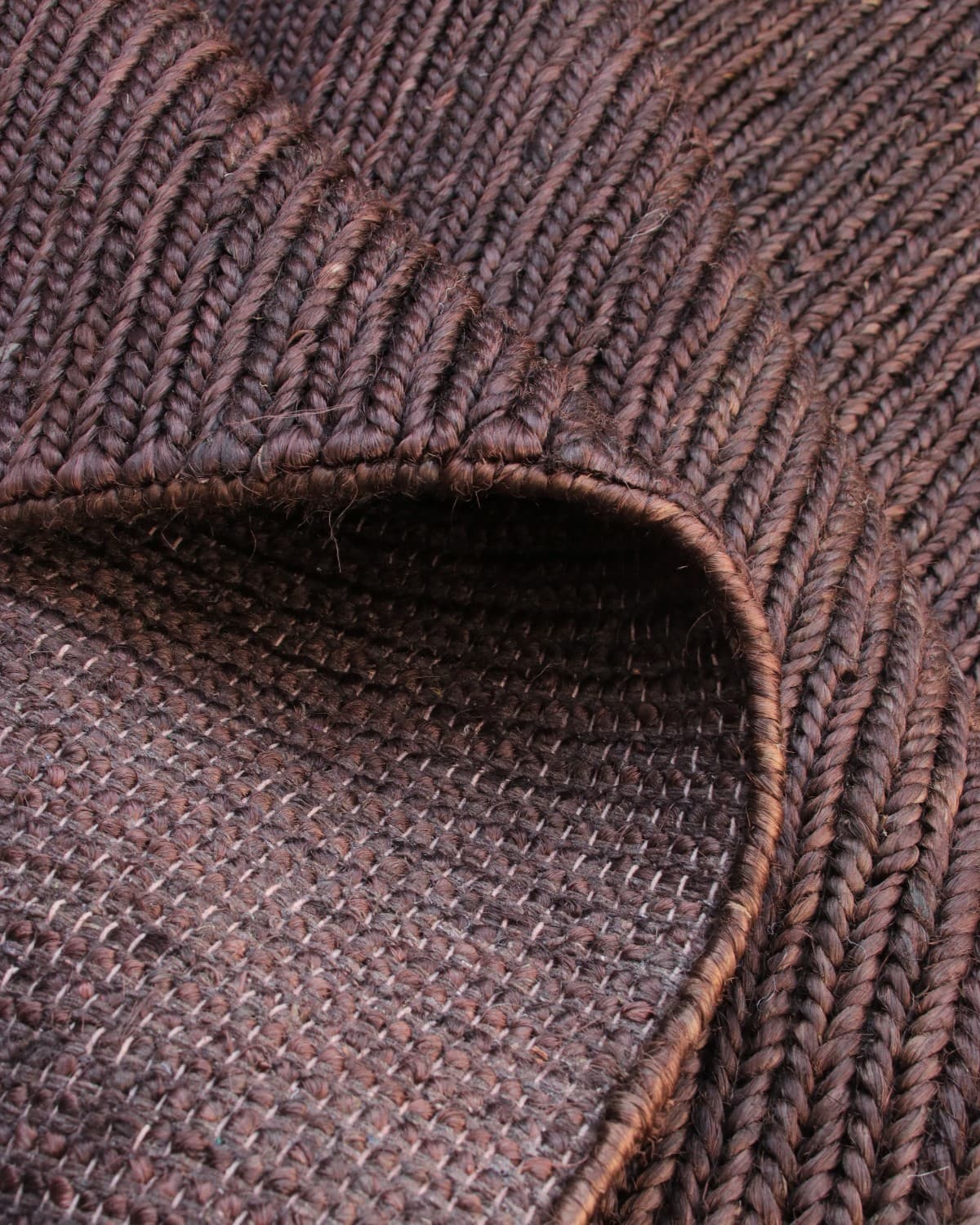 Folded corner displaying the durable underside, a GoodWeave certified design perfect for grounding a living room or bedroom.