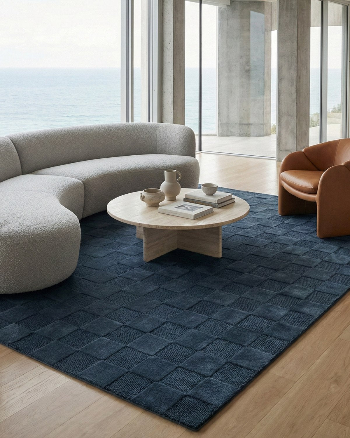 Styled in a modern living room, this hand-tufted rug brings architectural restraint and organic warmth to the floor.
