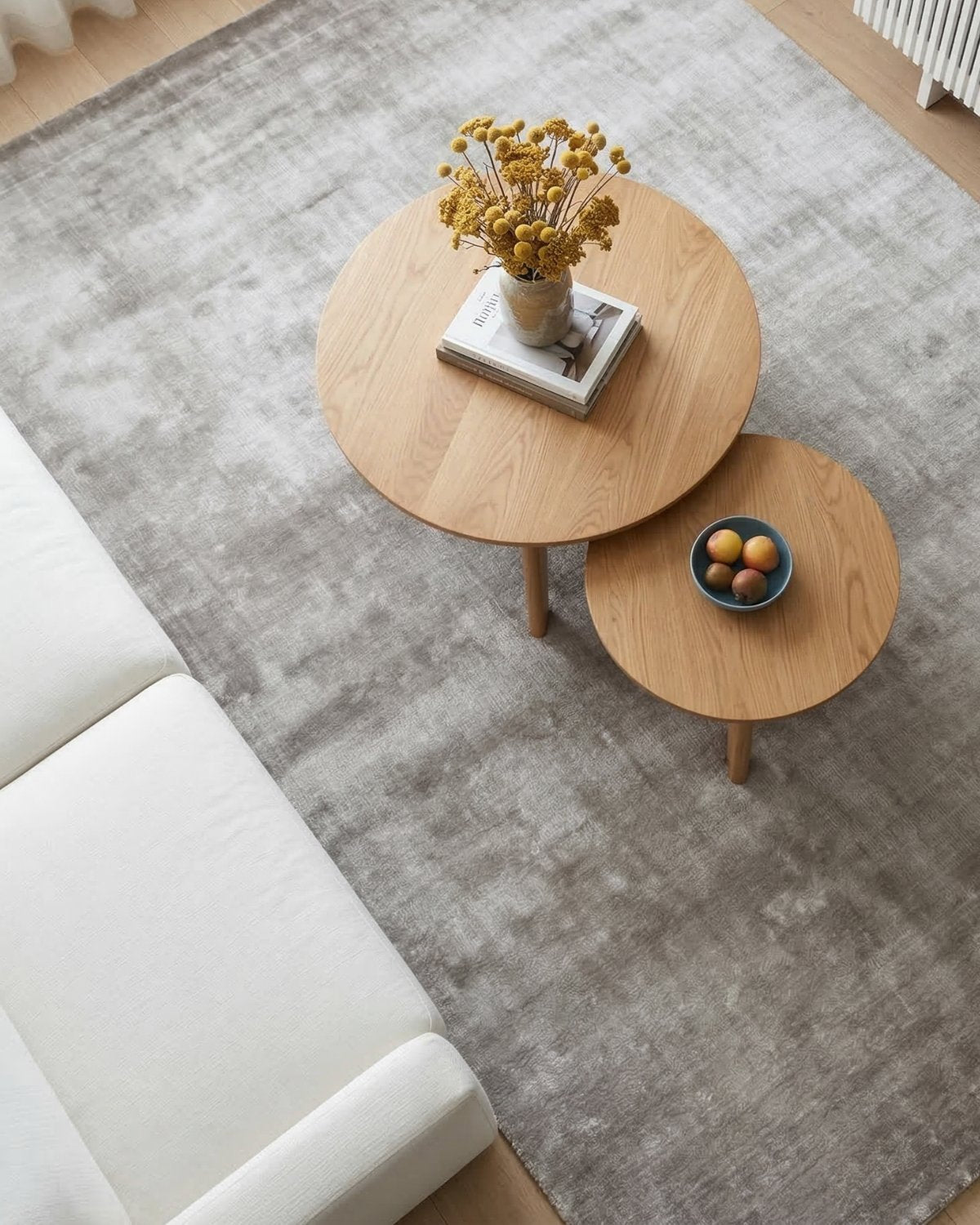 Dense cut pile area rug styled in a living room, bringing quiet, intentional elegance with its velvety texture.