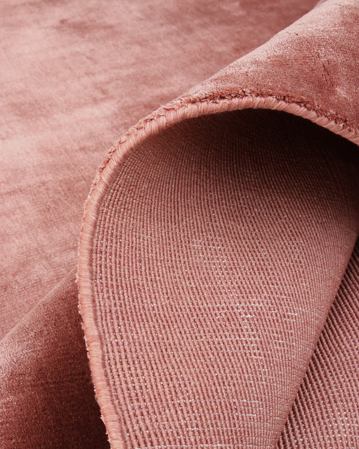 Folded corner revealing the secure edge binding and GoodWeave certified ethical construction from Bhadohi, India.