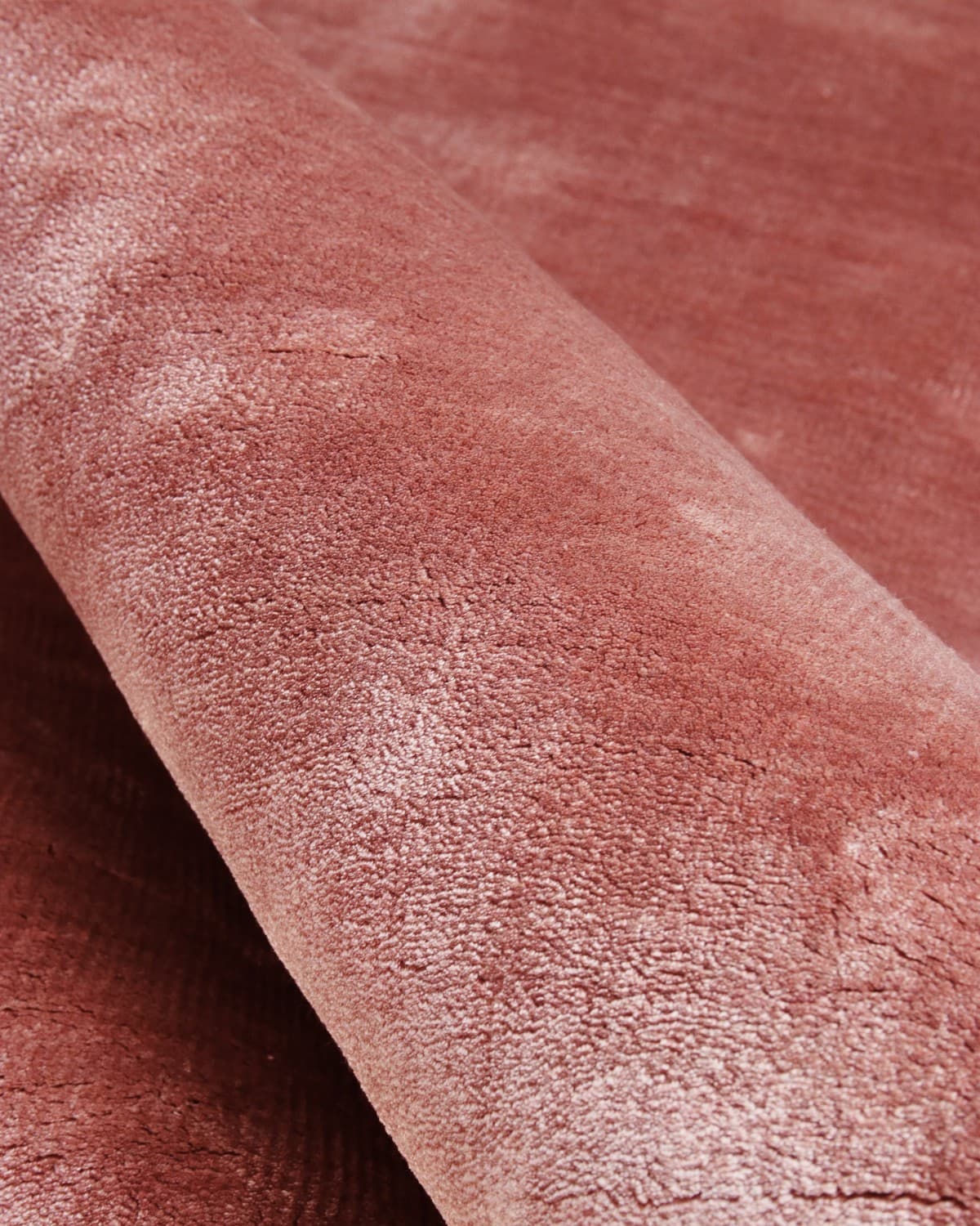 Close up of the handloomed 12mm pile, showcasing the soft natural fibres and shifting landscape of sheen and shadow.