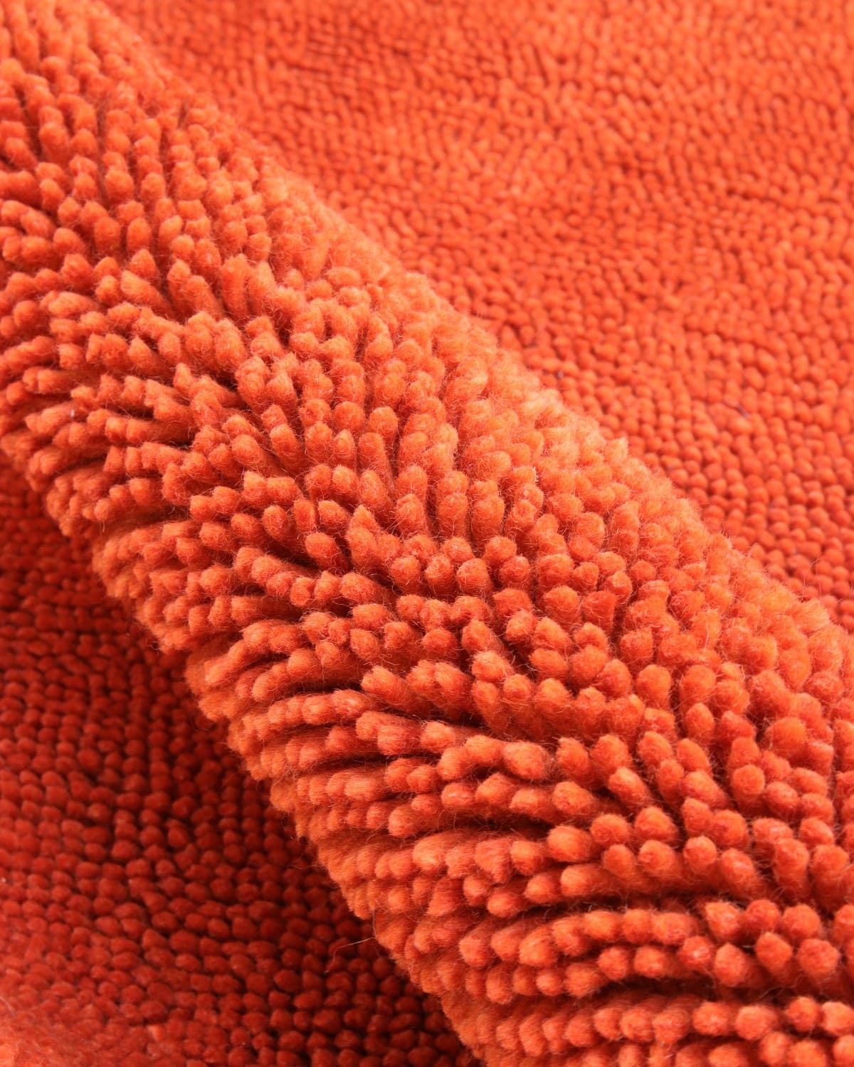 House of Bohi Raya burnt sienna area rug showcasing plush felted New Zealand wool texture.