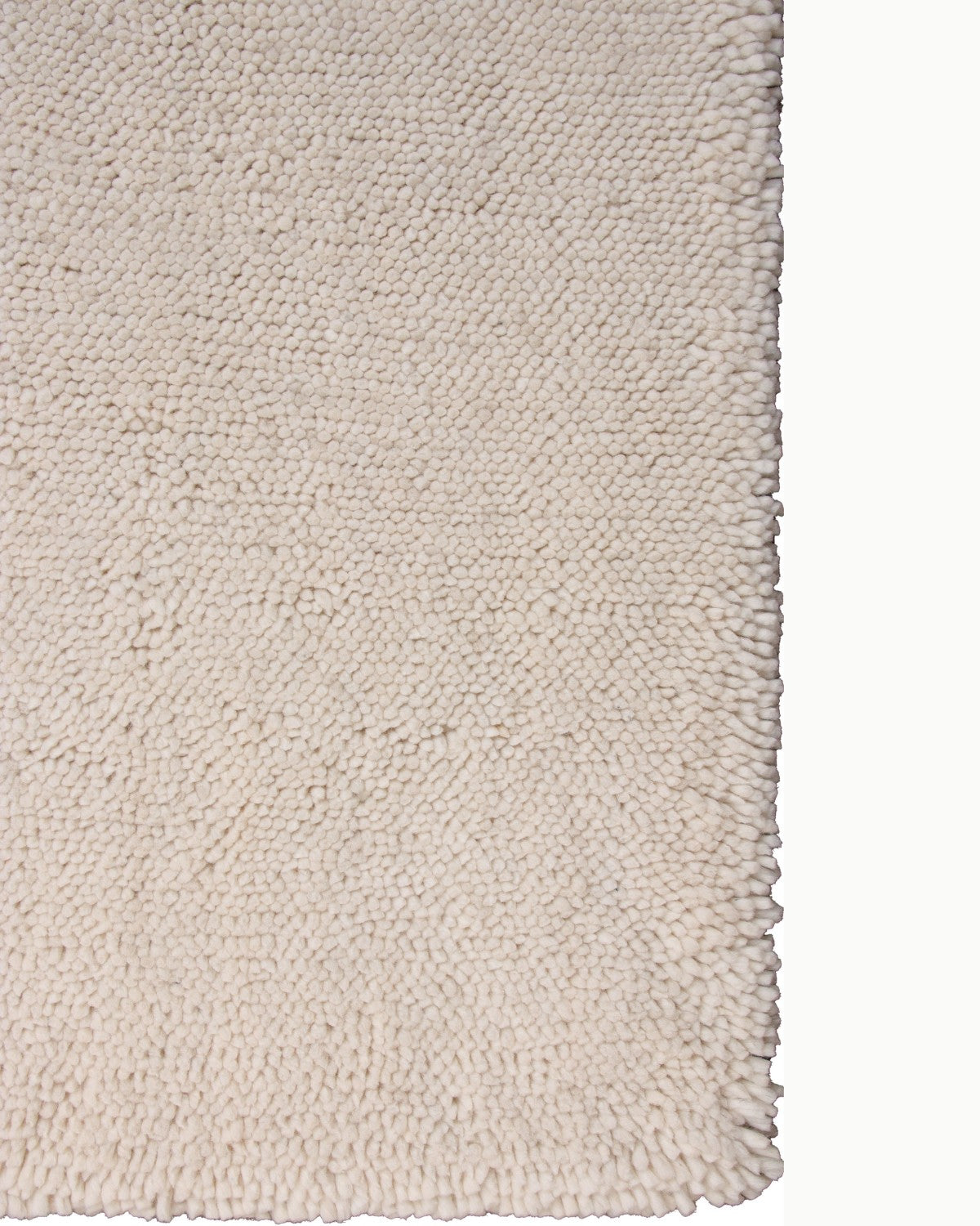 Close up lay-flat corner edge showcasing the dense, handcrafted structure of the felted natural fibres.
