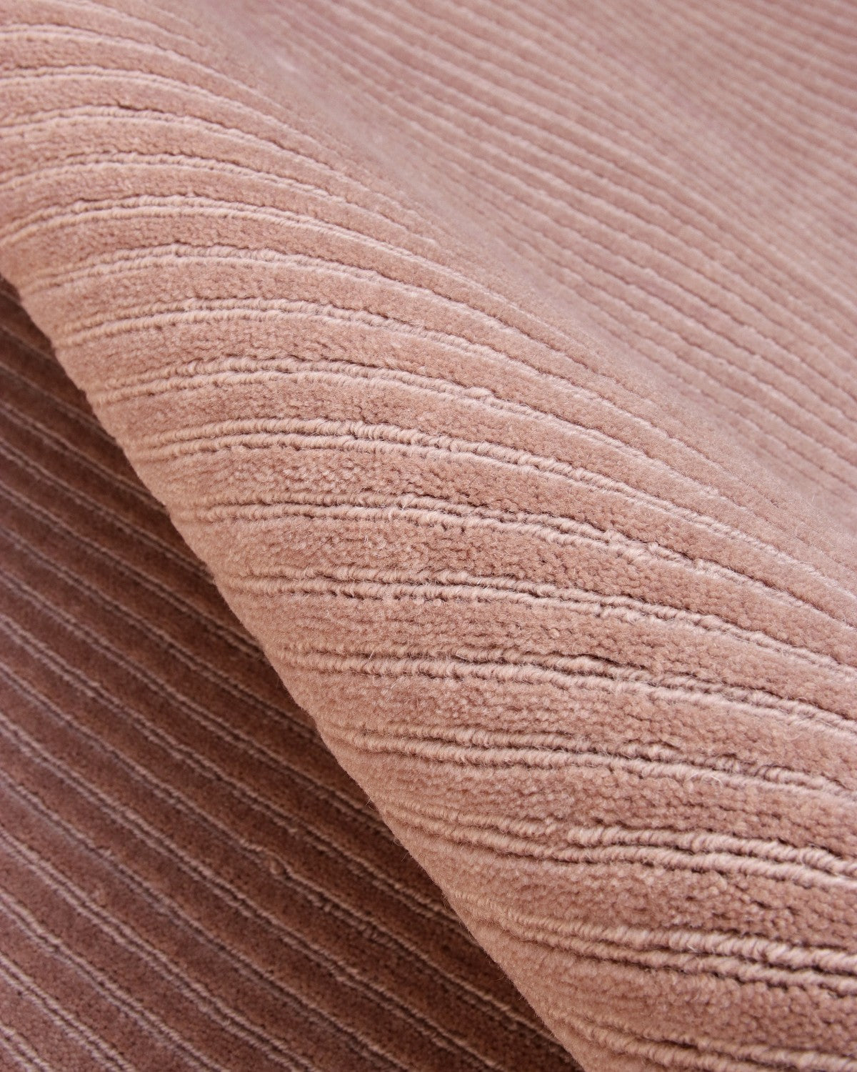 Macro detail of plush mushroom cut pile and fine loop-pile channels. A 12mm handloom weave for modern minimalism.