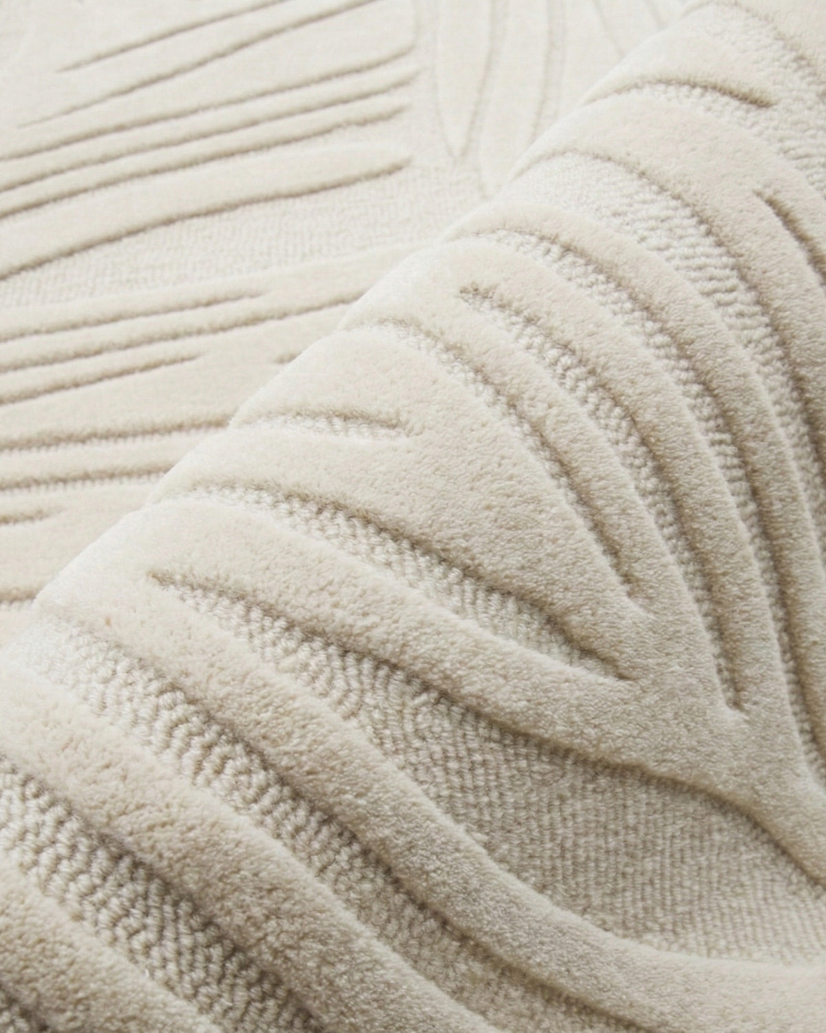 Folded ivory piece showcasing the plush 15mm pile height. An ethically produced, GoodWeave certified bedroom essential.