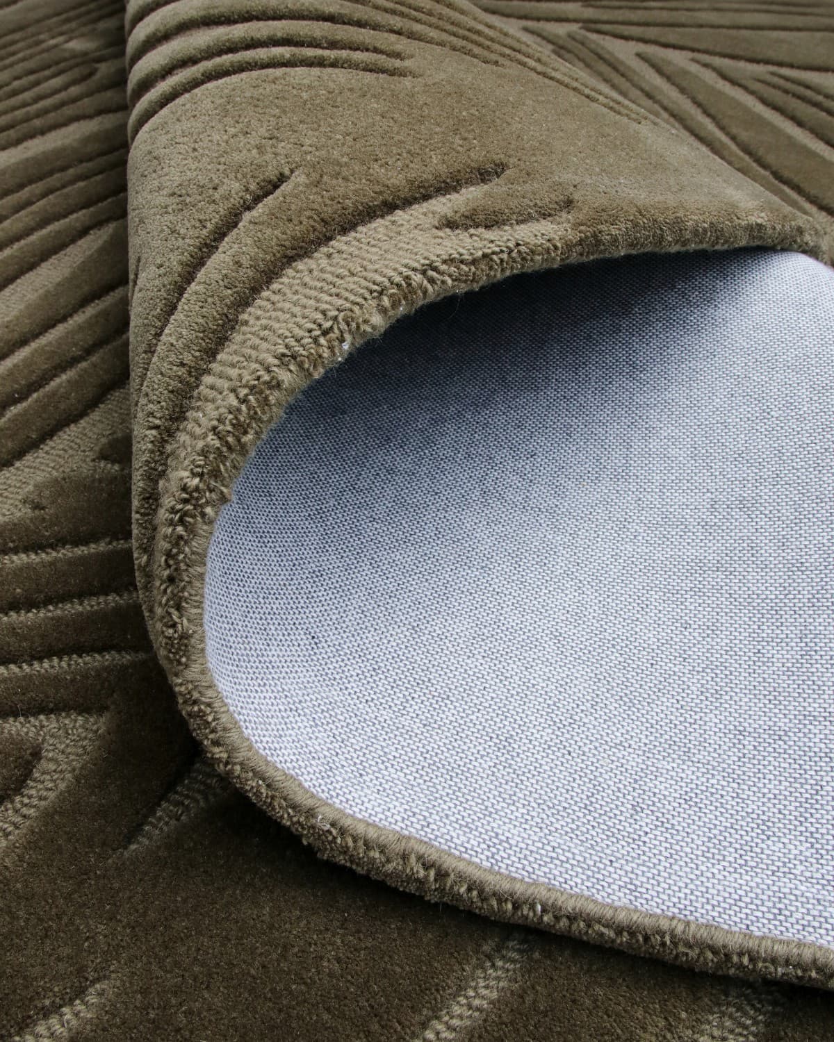Rolled corner revealing edge finishing and backing. This GoodWeave certified piece invites a moment of stillness to bedrooms.
