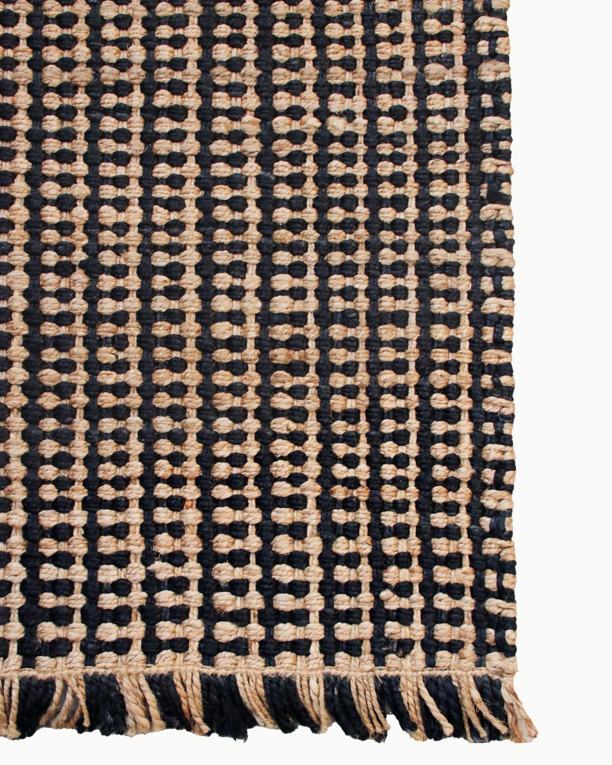 Lay-flat corner edge shot showing artisan fringe. Handmade in Bhadohi, it grounds mudrooms and entrances with relaxed ease.