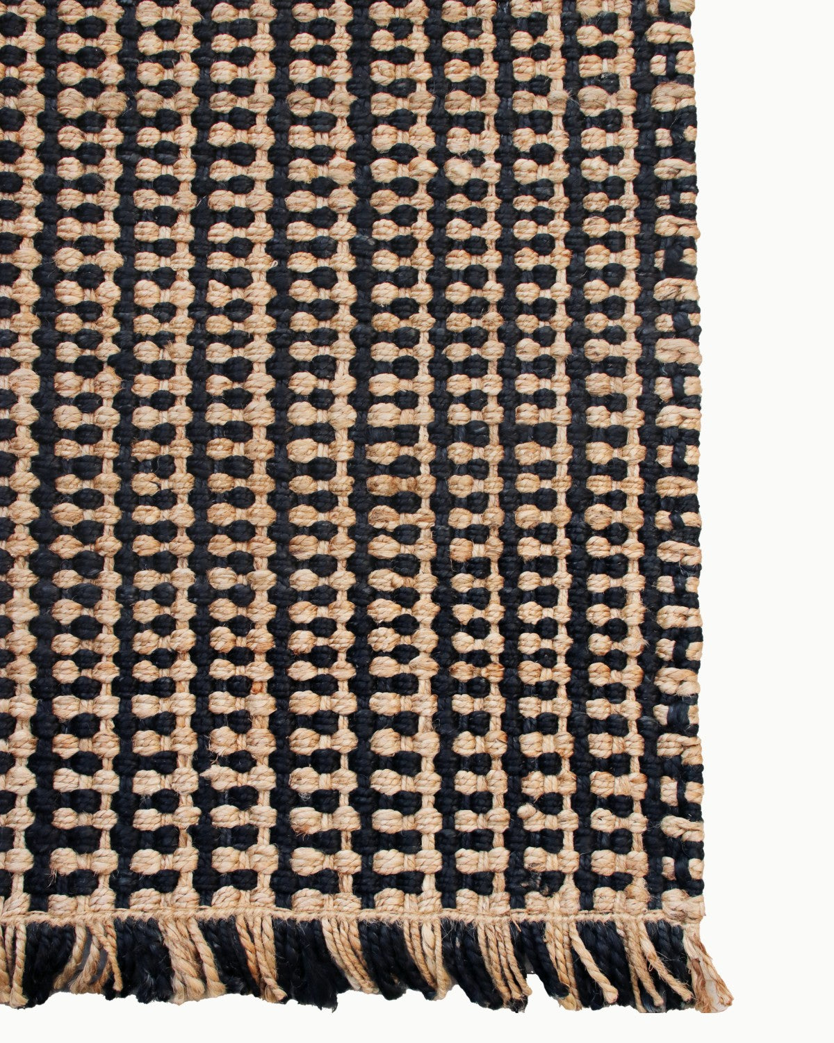Lay-flat corner edge shot showing artisan fringe. Handmade in Bhadohi, it grounds mudrooms and entrances with relaxed ease.