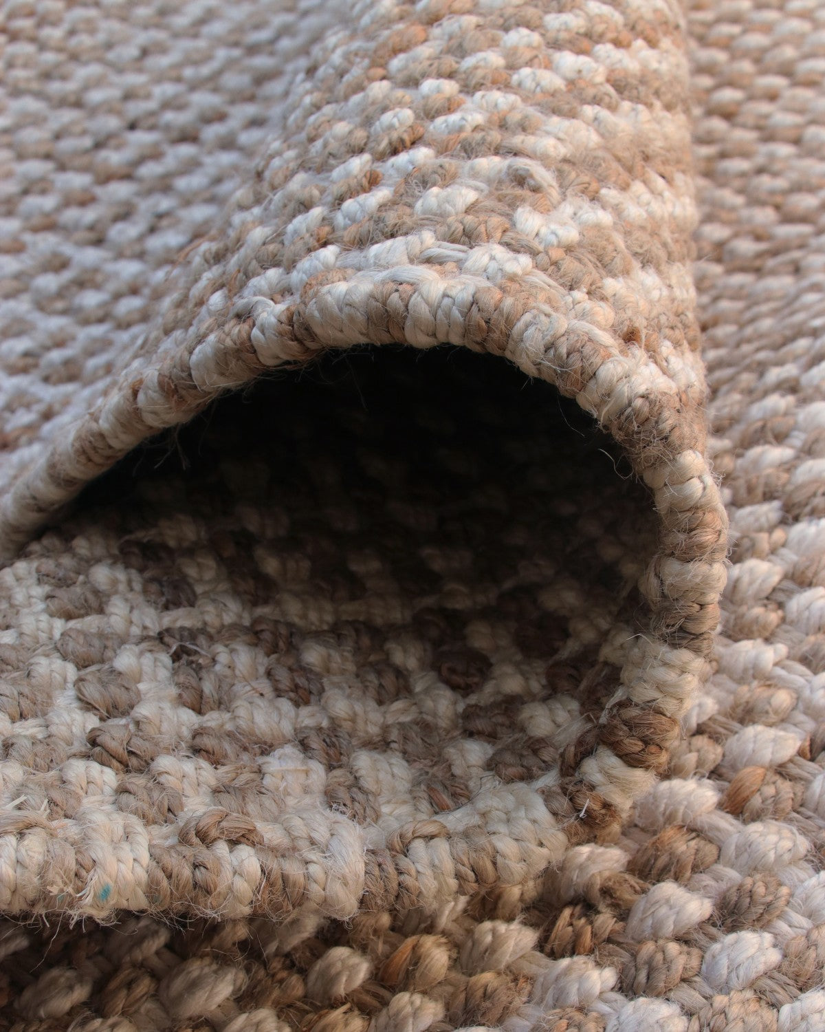 Folded piece revealing deep tactile relief and an 18mm pile height. Handmade in Bhadohi and GoodWeave certified.