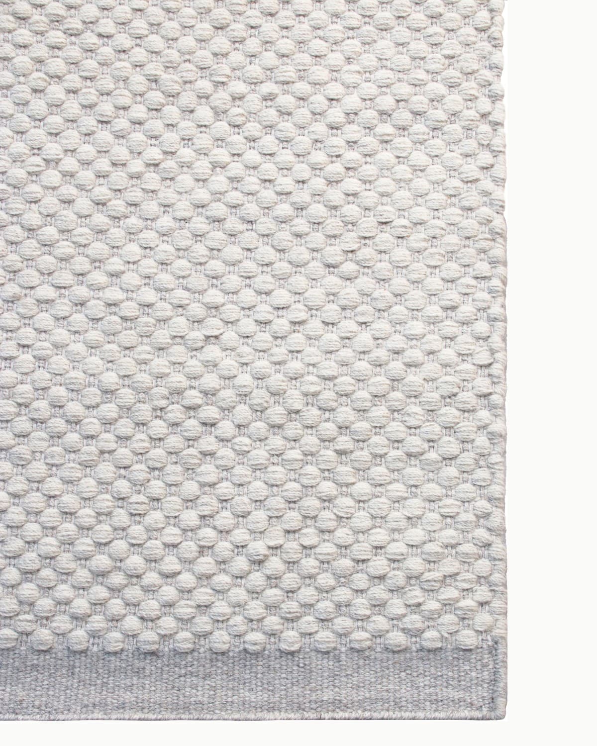 Durable corner finish perfect for a bedroom. Ethically handmade in Bhadohi, India, and GoodWeave certified.