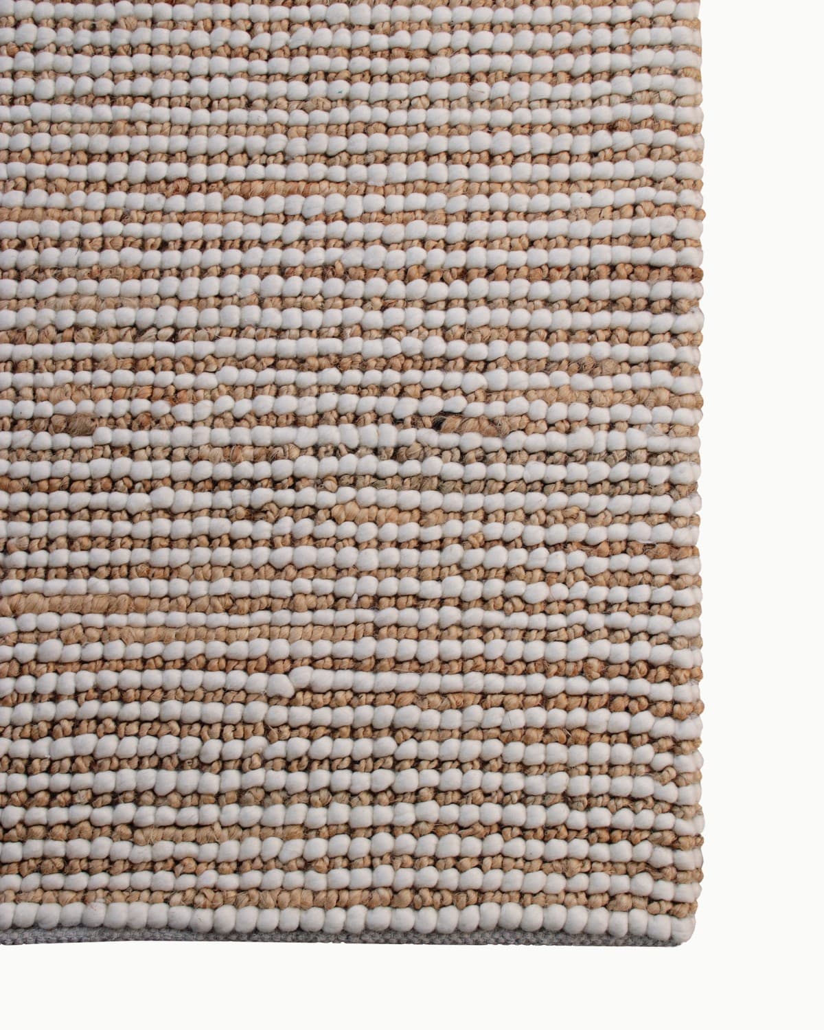 Top-down corner view showing the durable edge finish, perfect for a bedroom or living room. GoodWeave certified in Bhadohi.