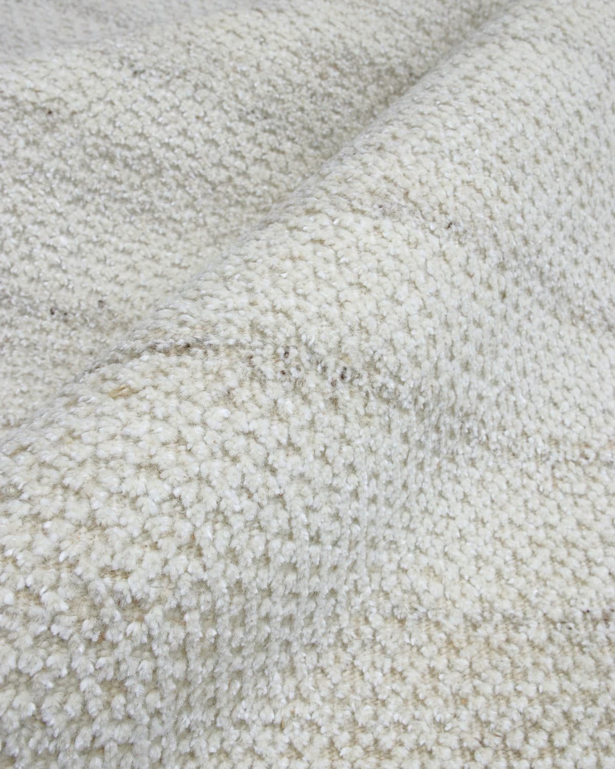 Close-up of a 10mm pile height waffle texture in undyed wool, ideal for grounding contemporary living rooms and bedrooms.