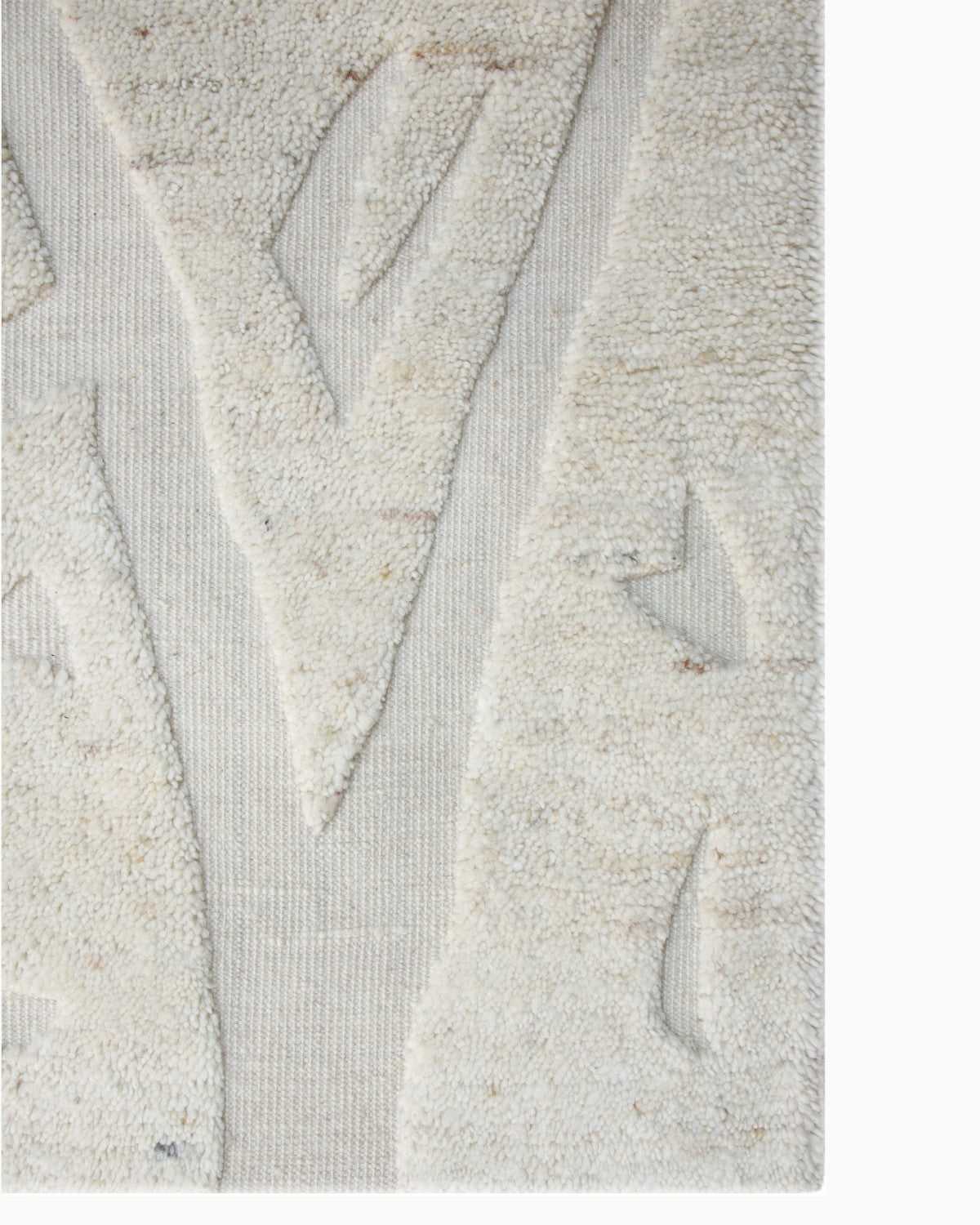 Detailed view of the handknotted weave and carved relief, showcasing traditional artisan techniques from Bhadohi, India.