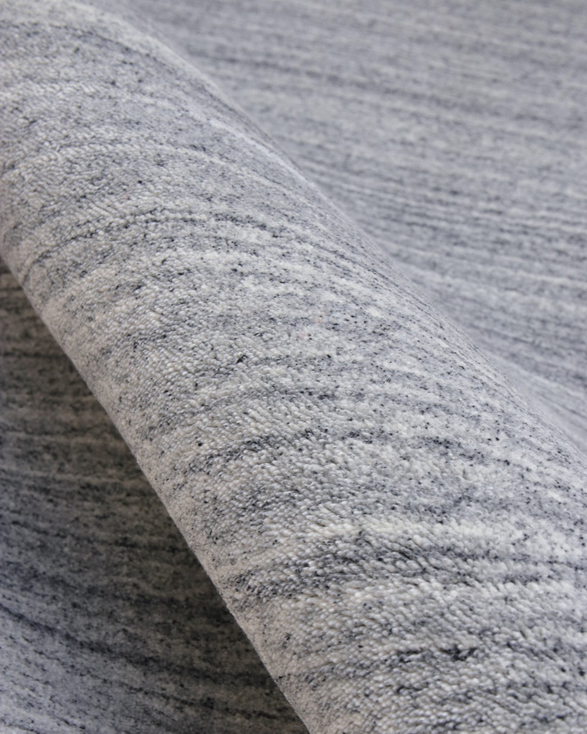 Close-up of a 70% New Zealand wool and 30% viscose blend, showing a lustrous sheen and a precise 12mm pile height.