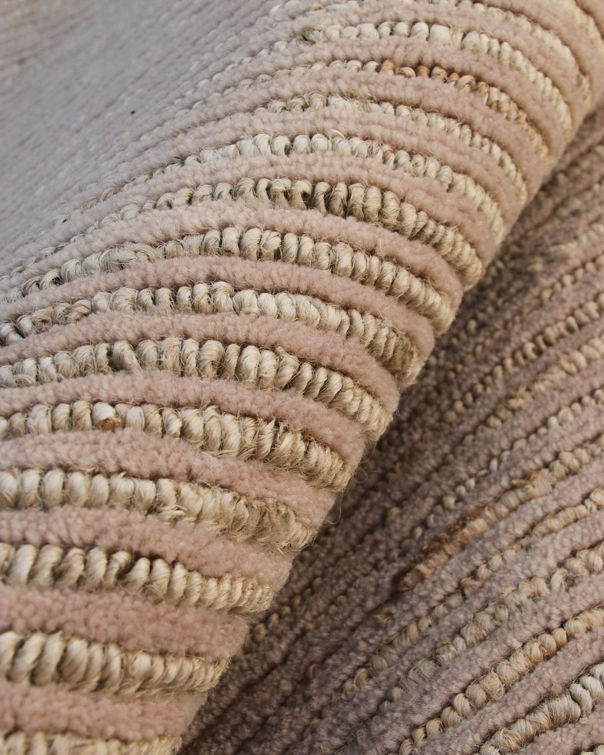 A macro view of the cut-and-loop handknotted texture, highlighting earthy elegance with alternating wool and sturdy jute.