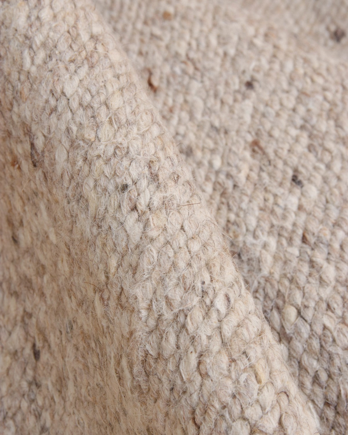 Close up of the handwoven flatweave technique revealing organic tonal variations and a rustic and refined texture.