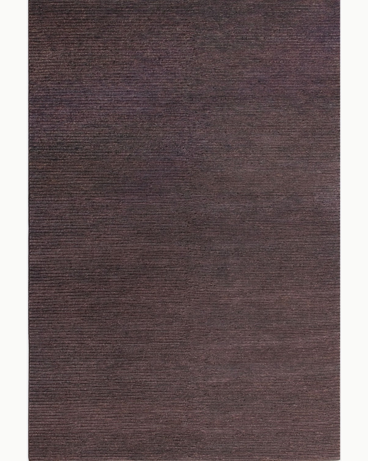 House of Bohi Nari area rug in chocolate. A full overhead view of this handwoven jute rug showcasing its rich brown tones.