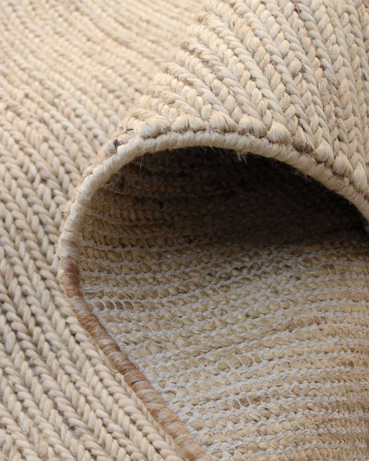 A folded corner showing the underside of this GoodWeave certified flatweave, an earthy anchor for a living room or bedroom.