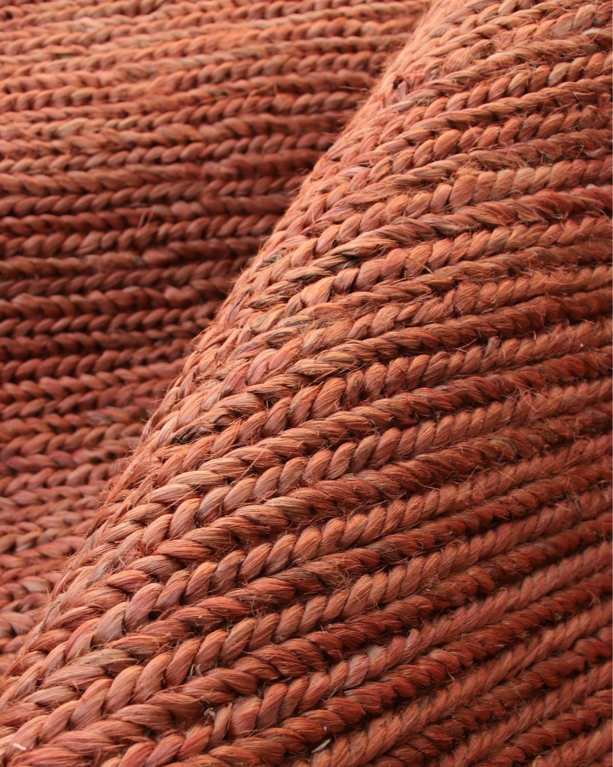 Extreme close up of the hand-harvested woven braids, highlighting the thick 12mm pile and relaxed tactile texture.