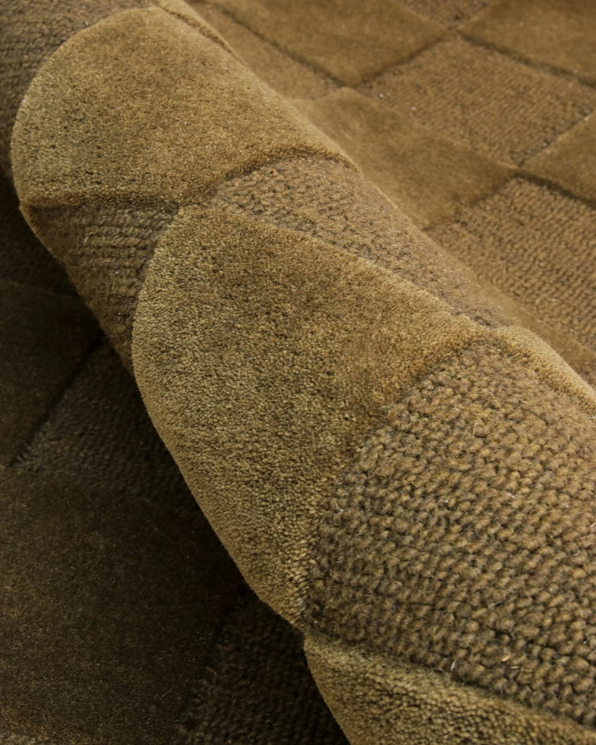 A close-up reveals the meticulous hand-tufted craftsmanship, featuring a plush 15mm pile height and tight loop weave.