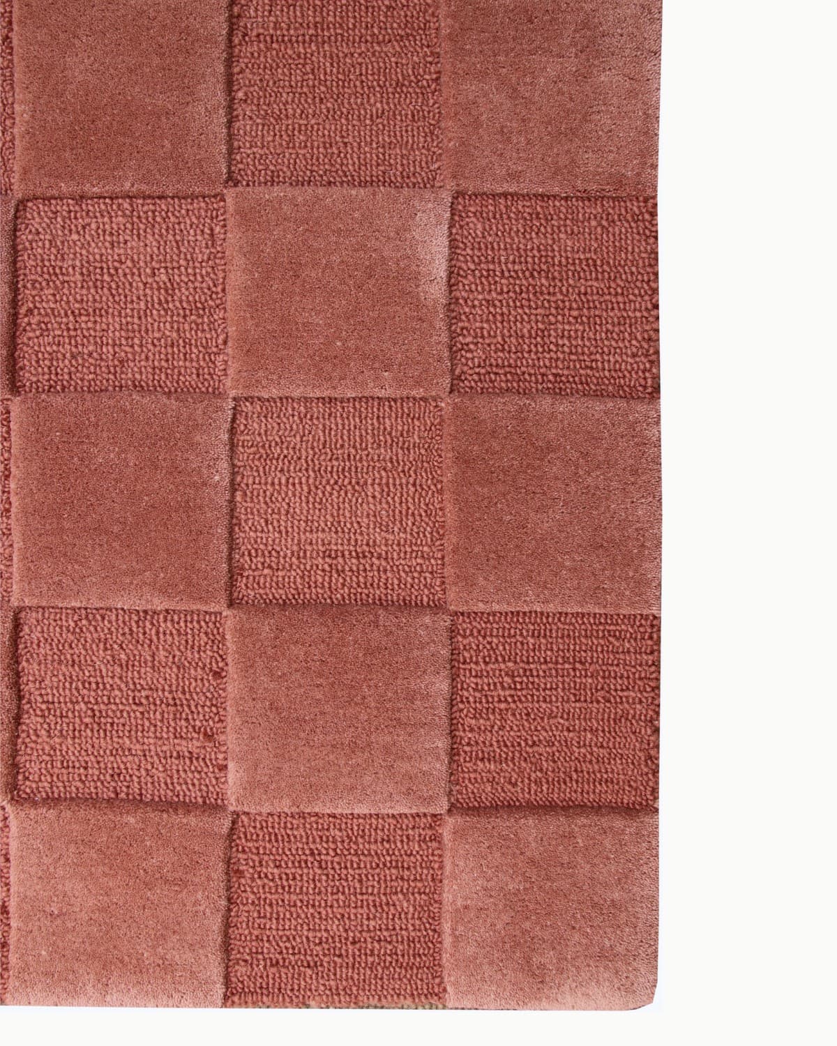 This tactile checkerboard design provides a geometric foundation for bringing organic warmth to a serene bedroom or living room.