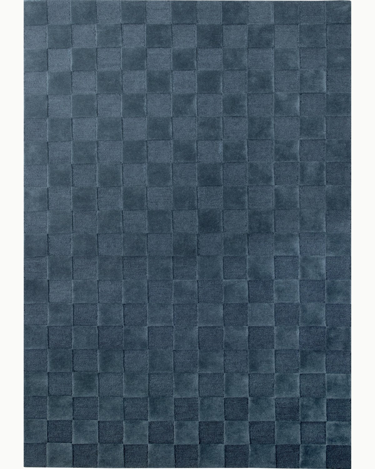 House of Bohi Navo area rug in slate blue, featuring a geometric checkerboard design hand-tufted from New Zealand wool.