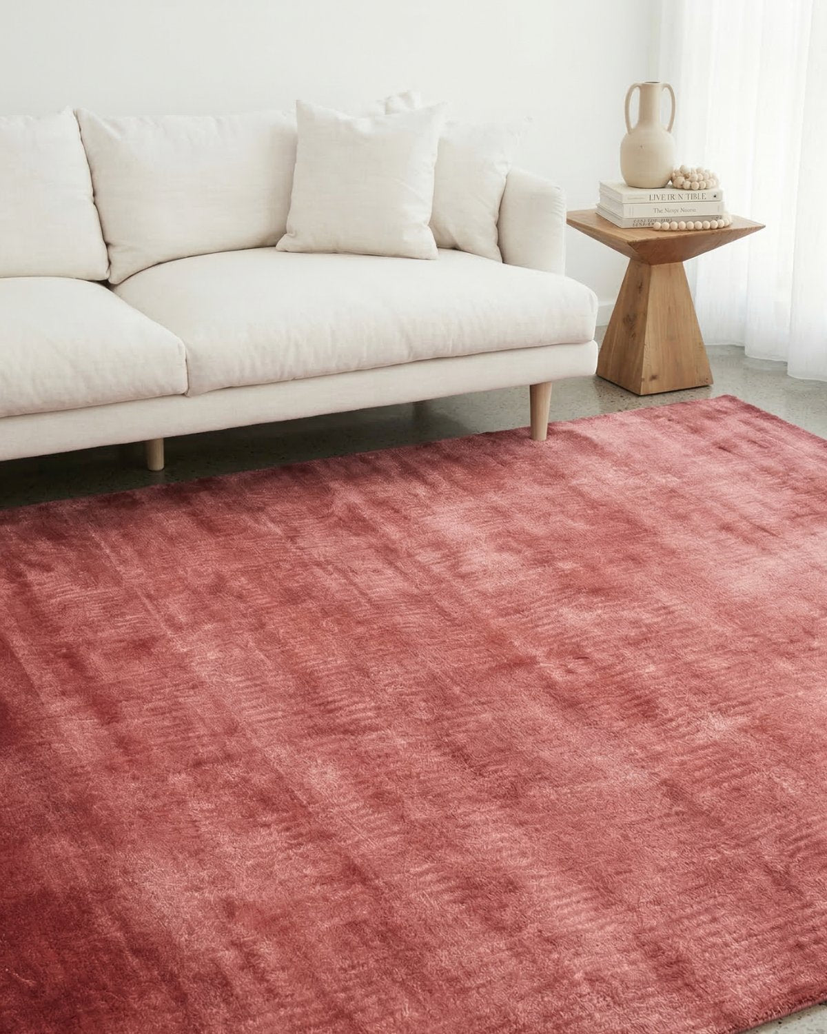 Dense cut pile flooring styled in a modern living room, bringing quiet, intentional elegance with its velvety texture.