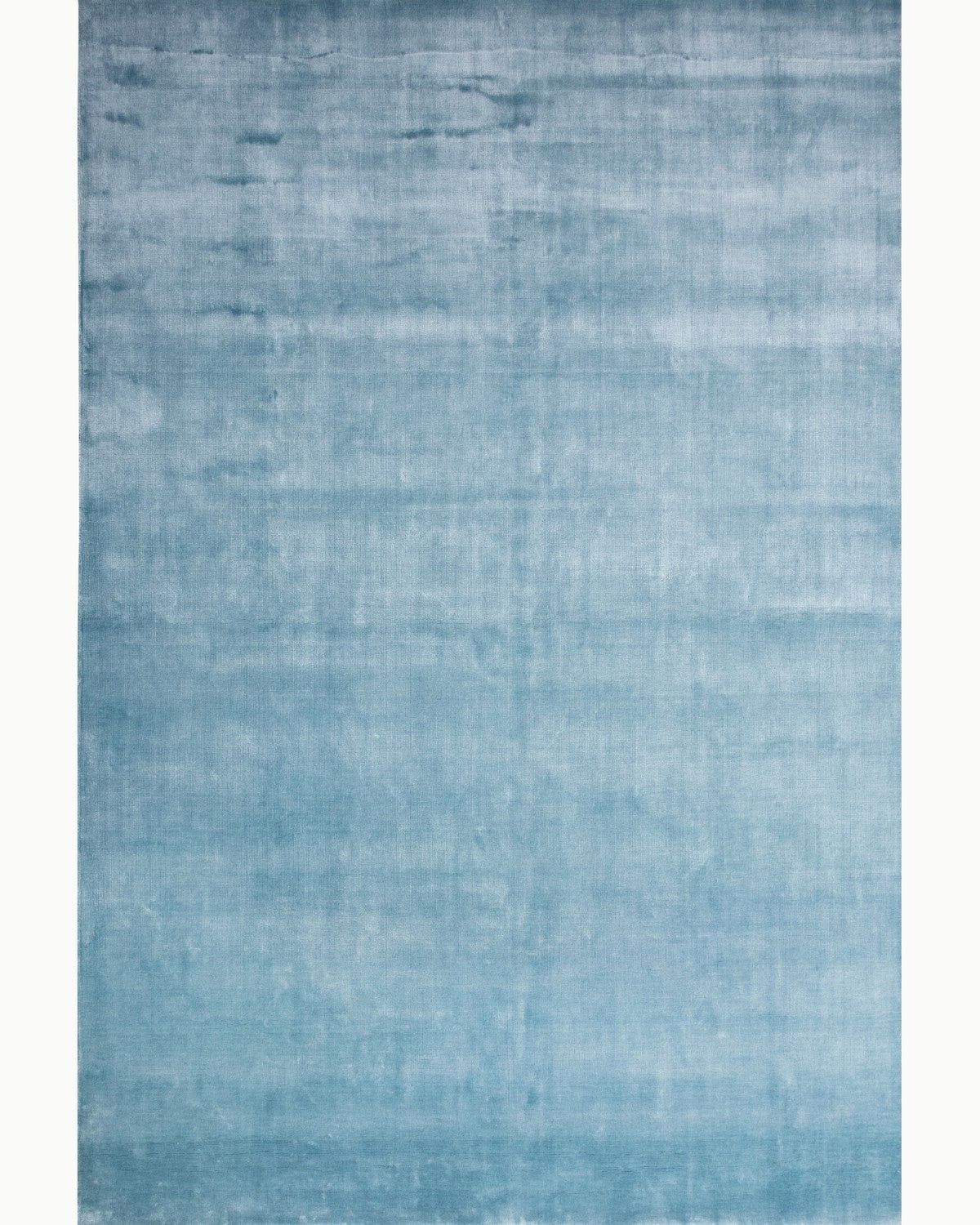 House of Bohi Noor steel blue area rug handloomed in silky Tencel, offering a luminous calm and understated opulence.