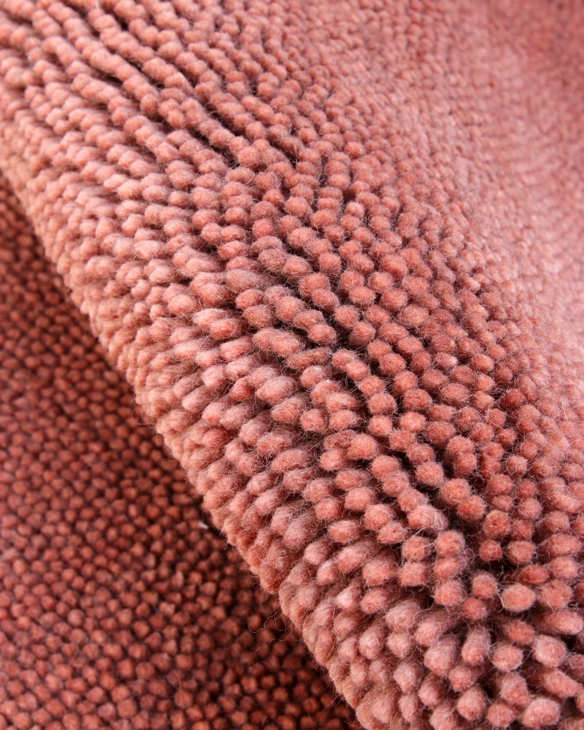 House of Bohi Raya area rug in rosewood. A modern shag crafted from felted New Zealand wool with a dense, nubby texture.
