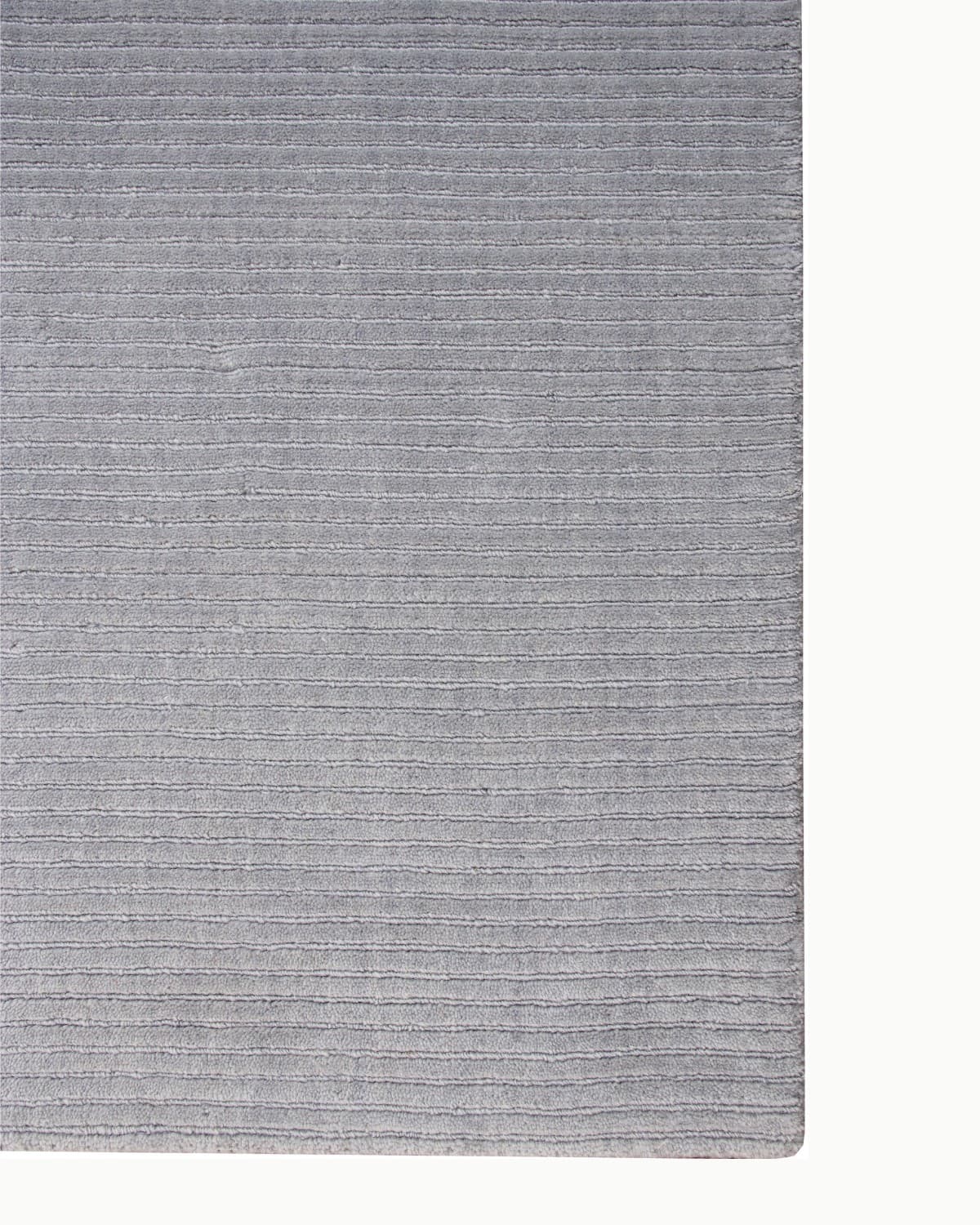 Lay-flat corner edge shot displaying straight handloomed ridges. Inspired by the serene continuity of the horizon.
