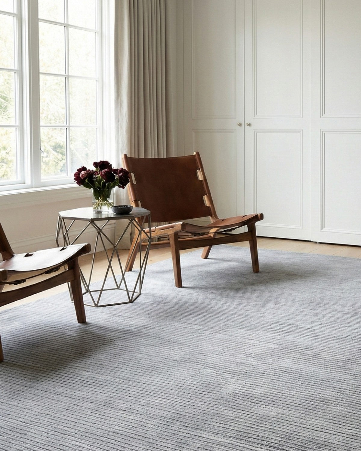 Living room setting featuring a subtle ribbed texture floor covering. The sleek tactile presence balances plush softness.