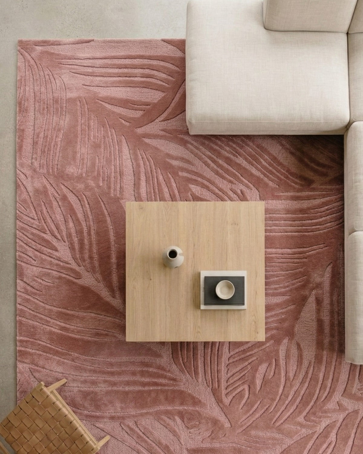 Sculptural floor covering styled under a coffee table. Handtufted lines move across the space catching light and shadow.