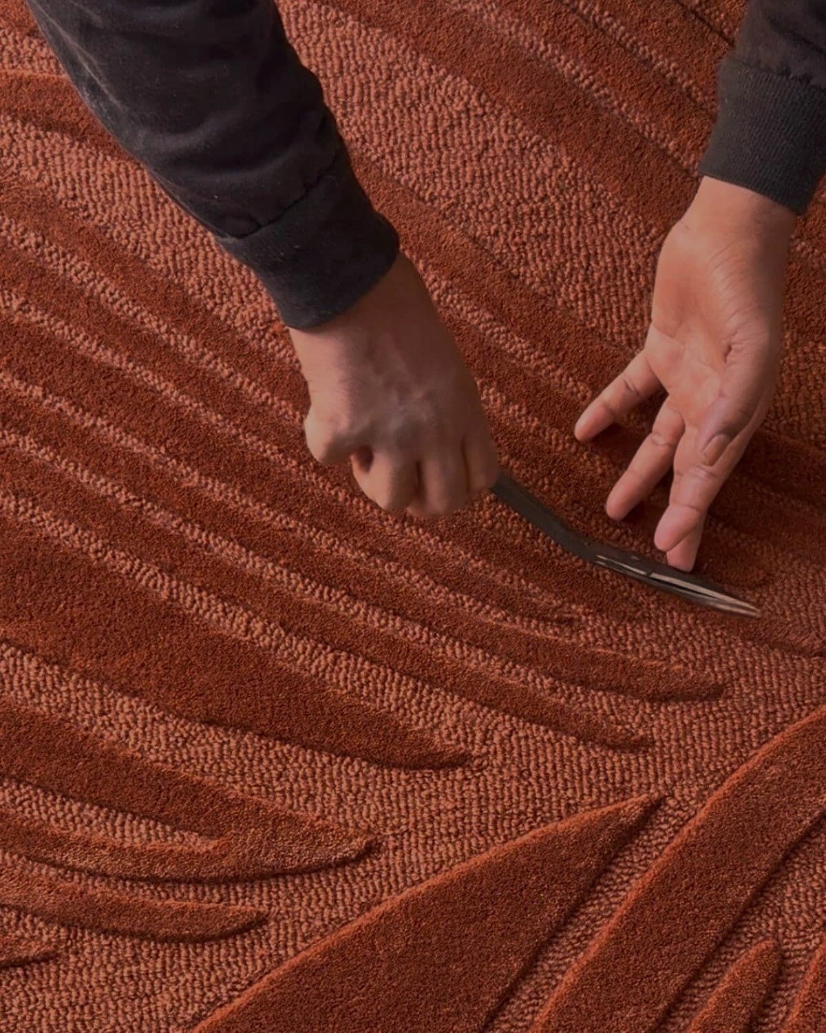 Artisan hand-carving the custom lines. Showcases the authentic craftsmanship of this piece handmade in Bhadohi, India.